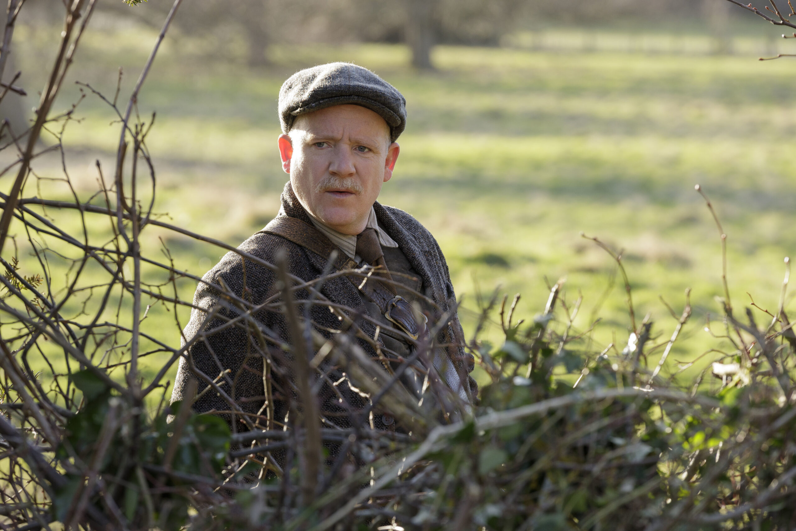 Richard Glover as Maddocks in Ghosts, he looks up from a badger trap outside Button House