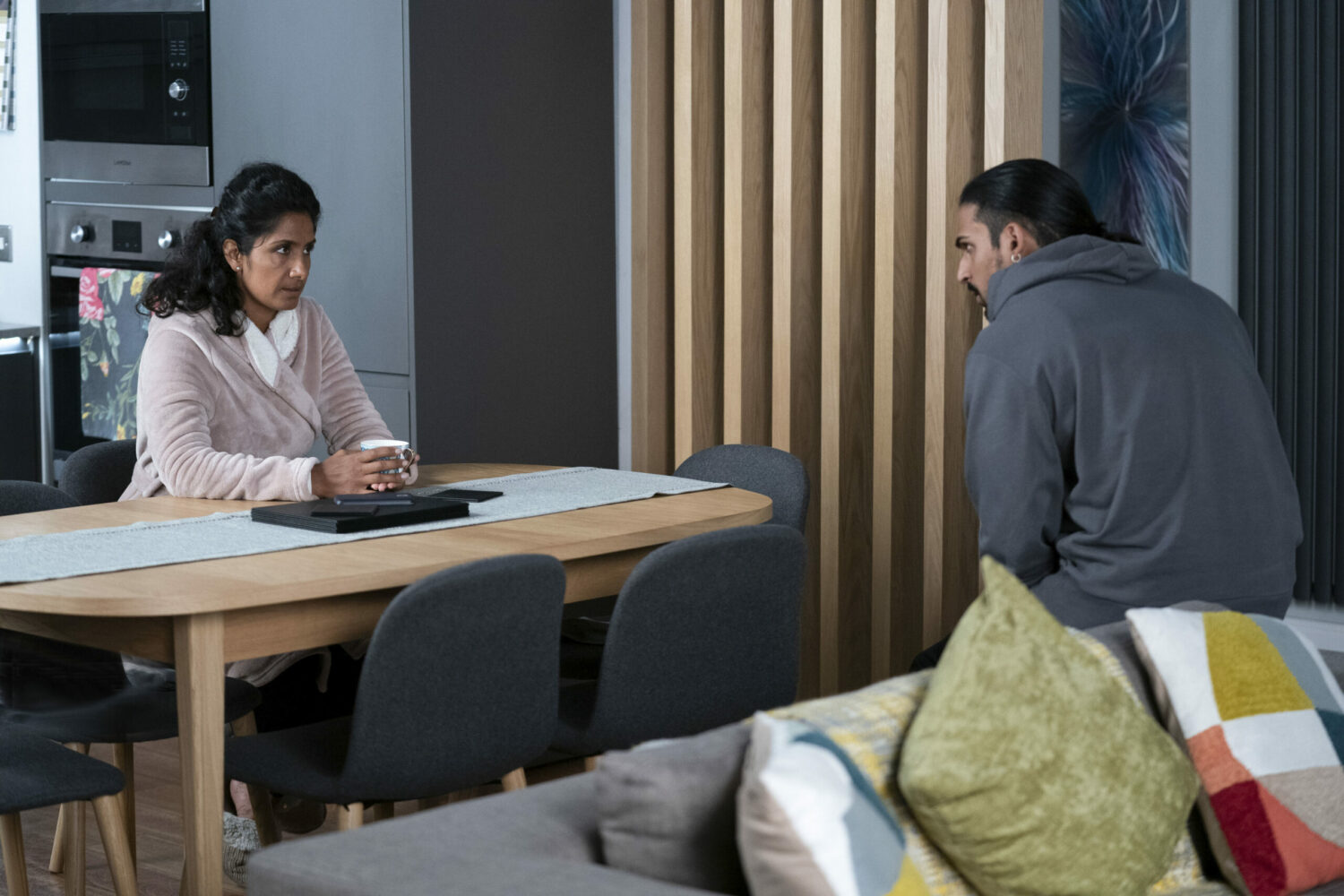 Suki in EastEnders looks serious in her dressing gown