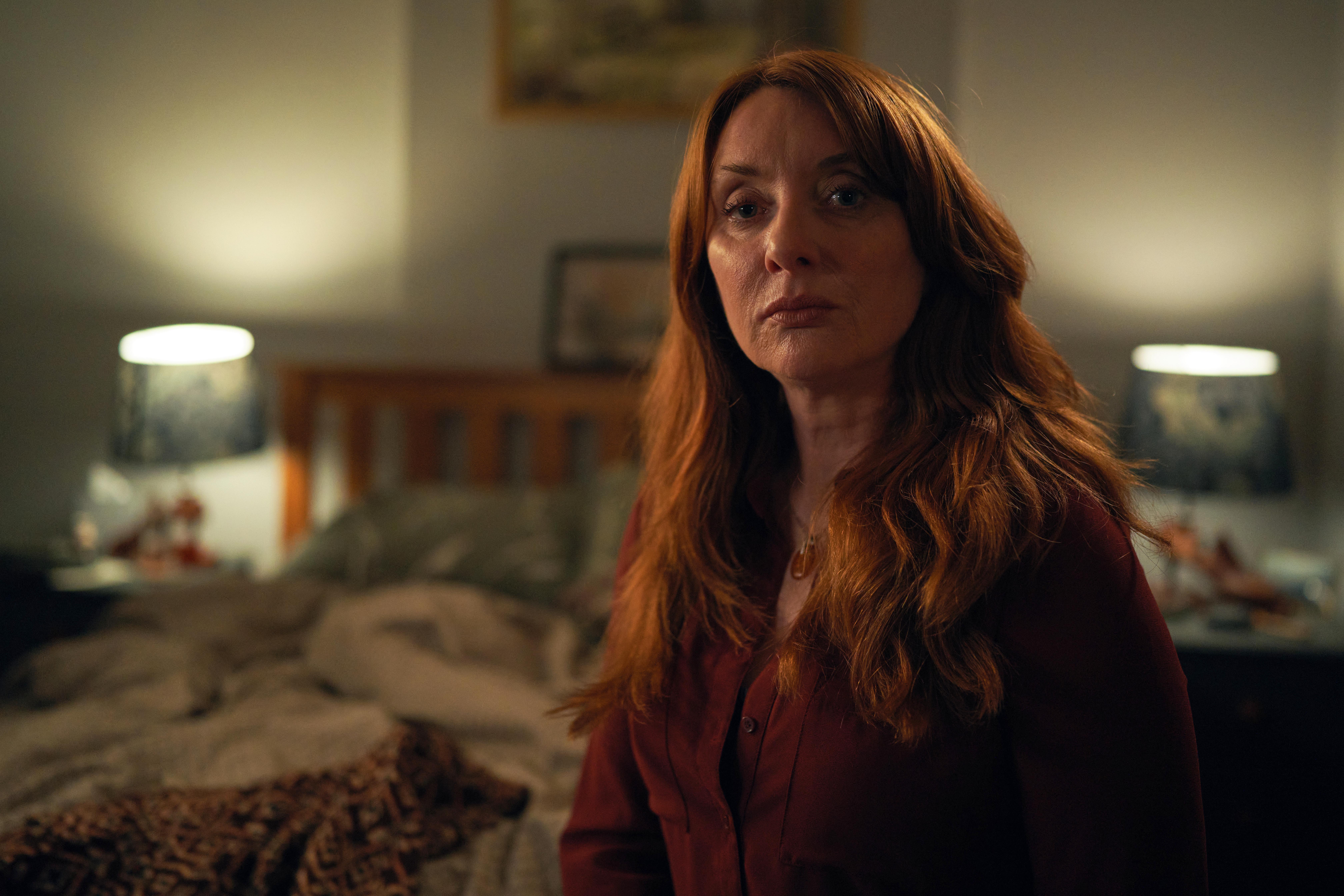 Elizabeth Berrington as Kate sitting in bedroom looking wistful