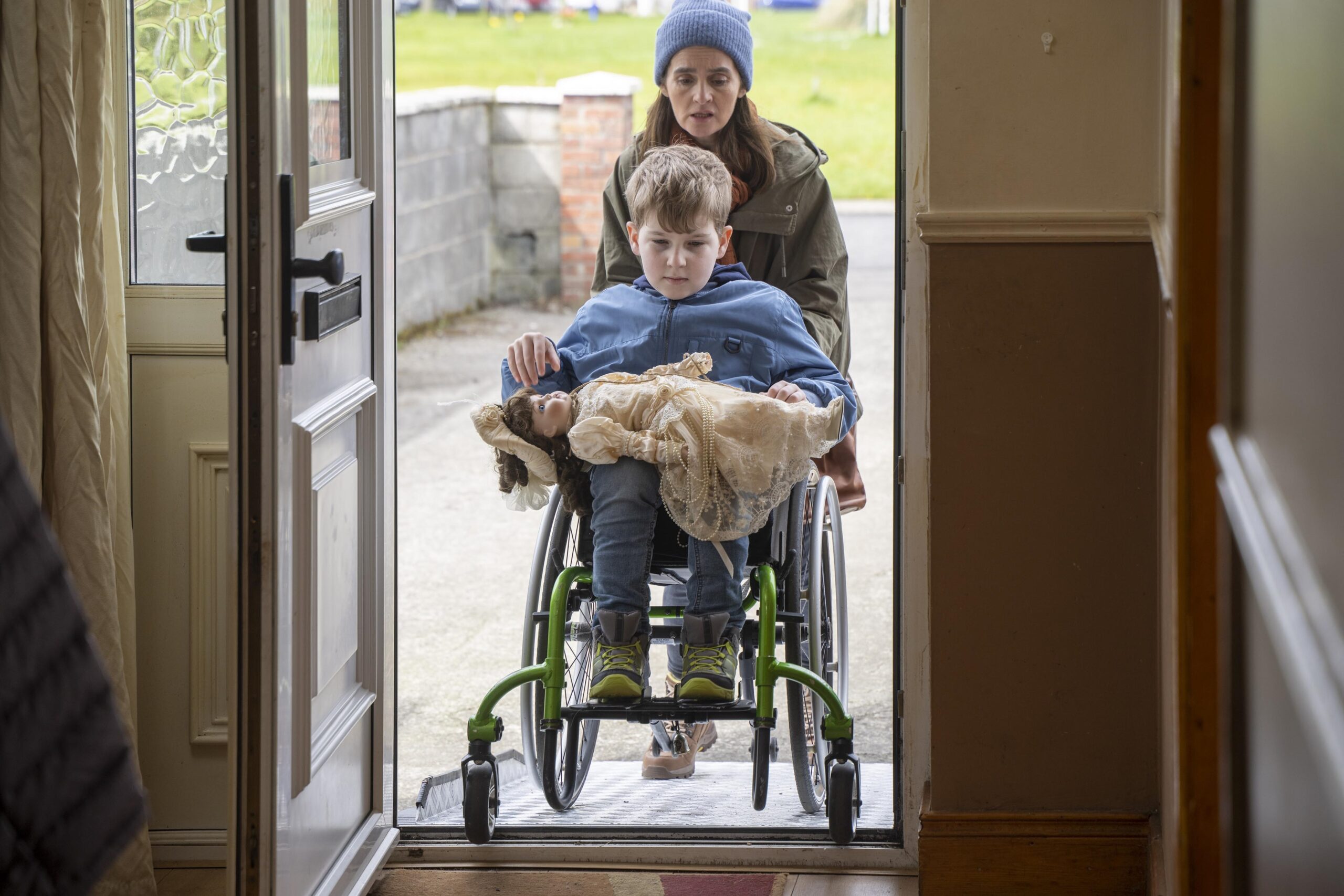 Shirley Henderson as Claudia in House Across The Street pushing Eddie Brett as Simon in his wheelchair into his house
