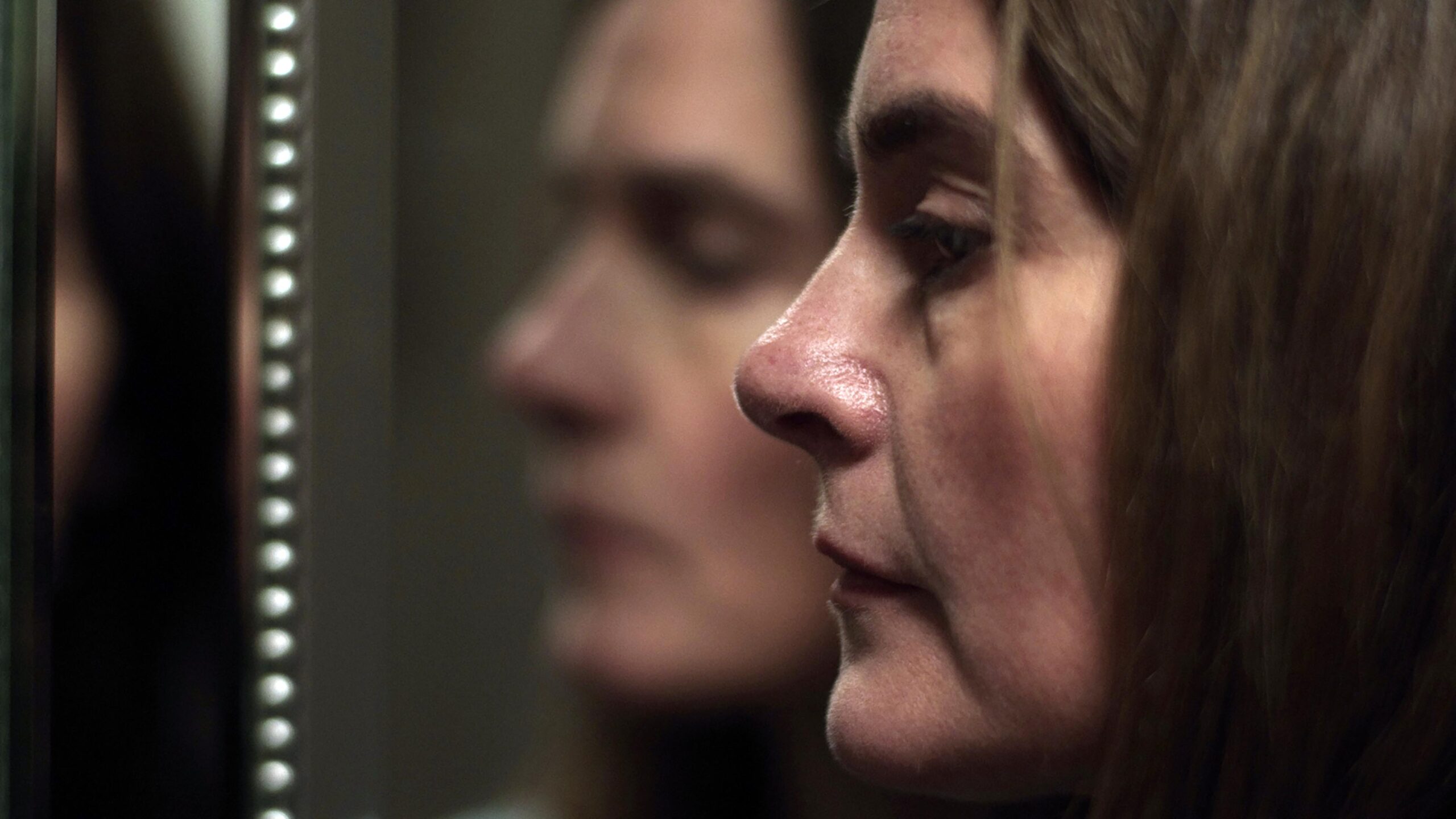 SHIRLEY HENDERSON AS CLAUDIA IN THE HOUSE ACROSS THE STREET, she looks into a mirror with an upset expression