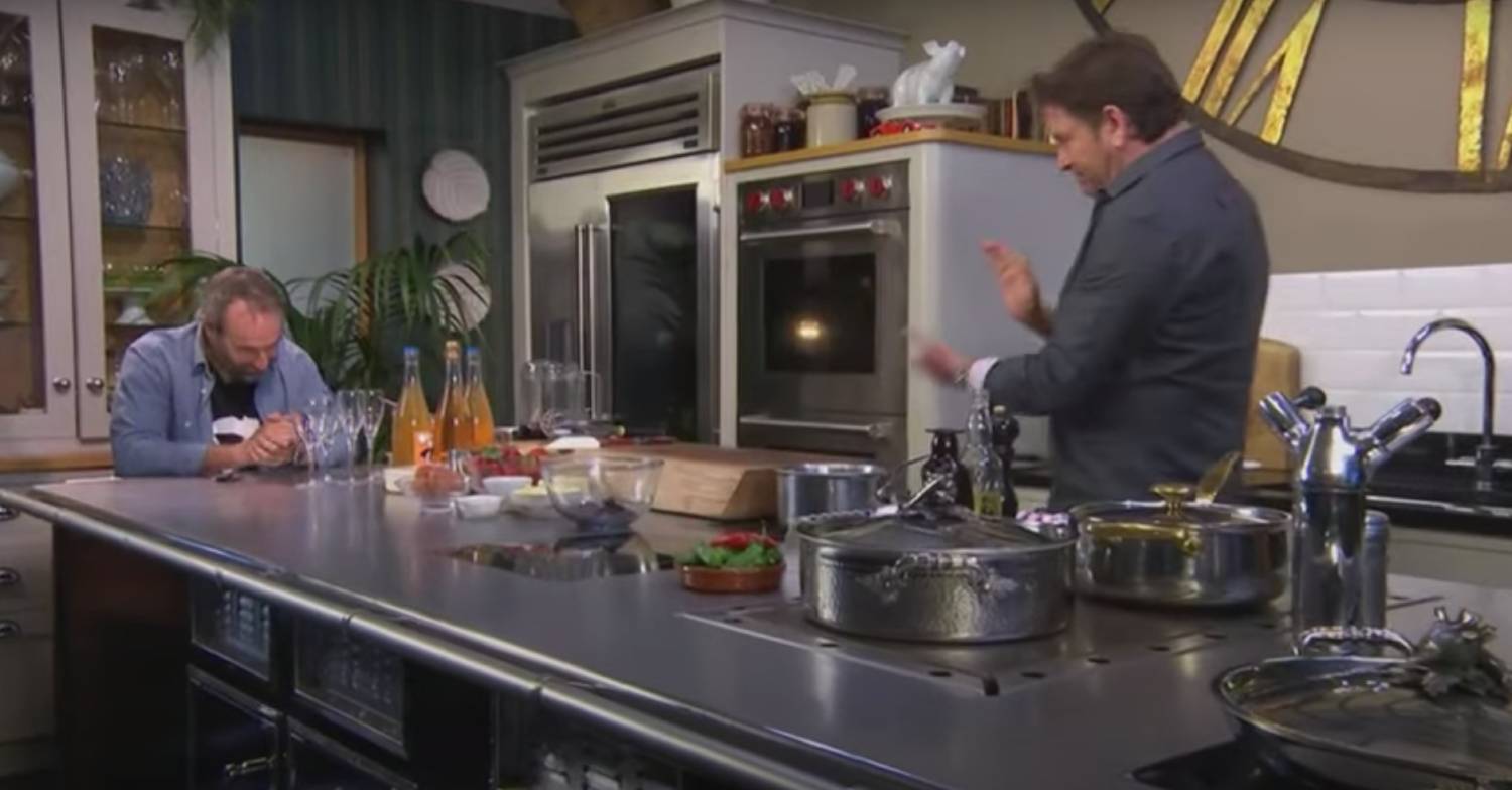 James Martin greets a guest to his kitchen