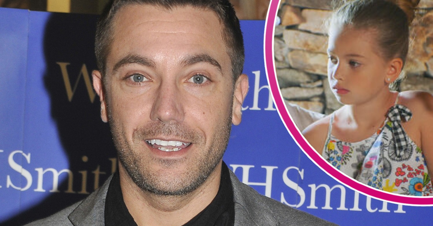 Family Fortunes host Gino D'Acampo on the red carpet holding his cook book