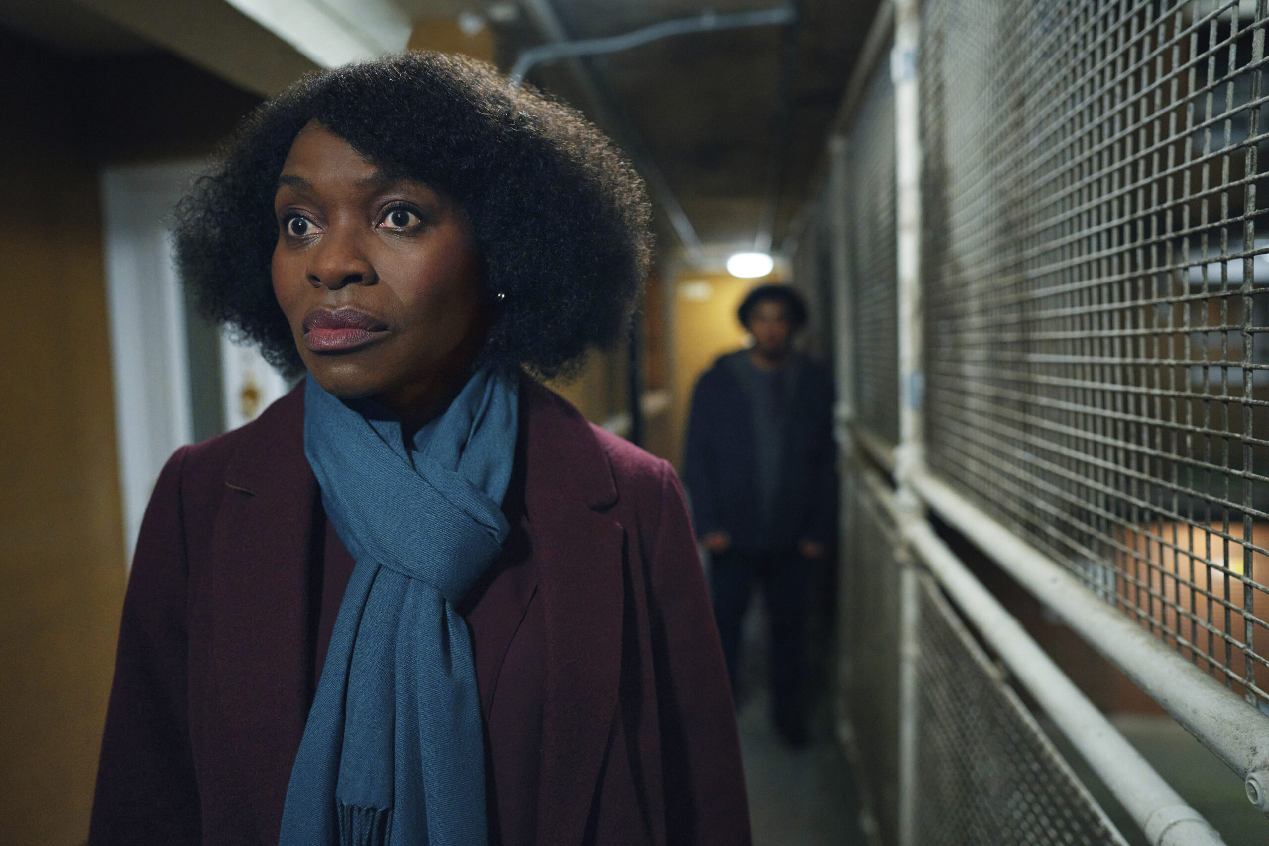 Rakie Ayola stands in front of a menacing Connor, lookig scared, in The Pact season 2 cast