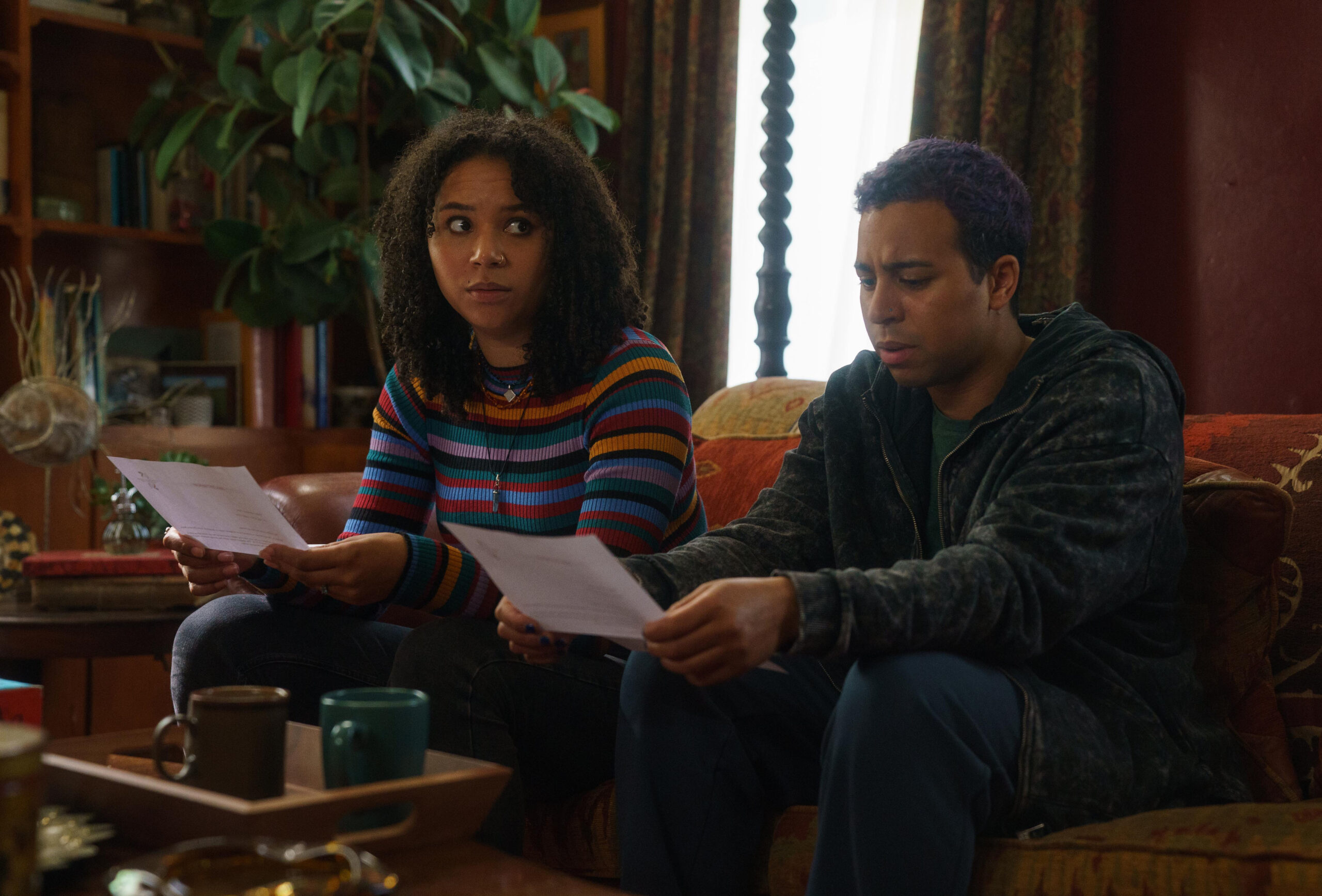 Megan and Jamie on the soft in their family home reading documents in The Pact series 2 episode 1