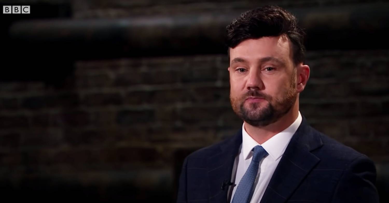 Dragons' Den contestant Drew Cockton listens while making his pitch