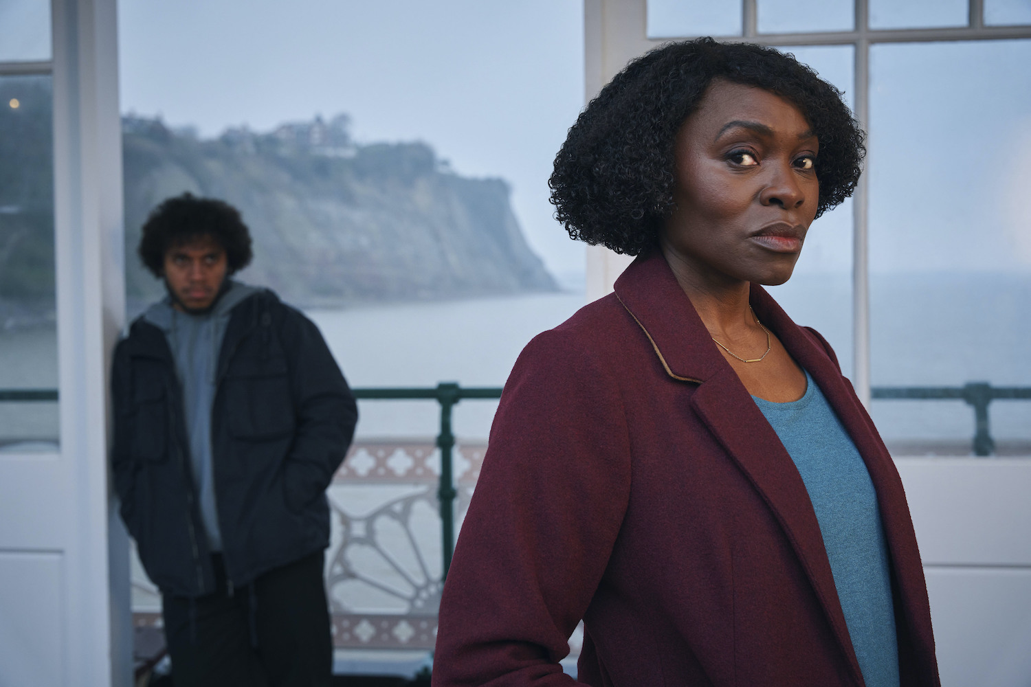 Rakie Ayola as Christine standing on Penarth Pier in front of Connor (Jordan Wilks)