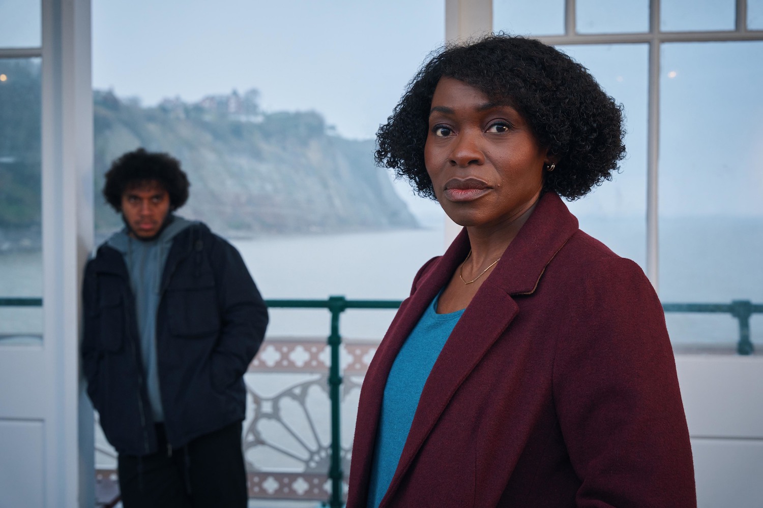 Rakie Ayola in character as Christine in the Pact series 2, standing on a pier in front of Connor