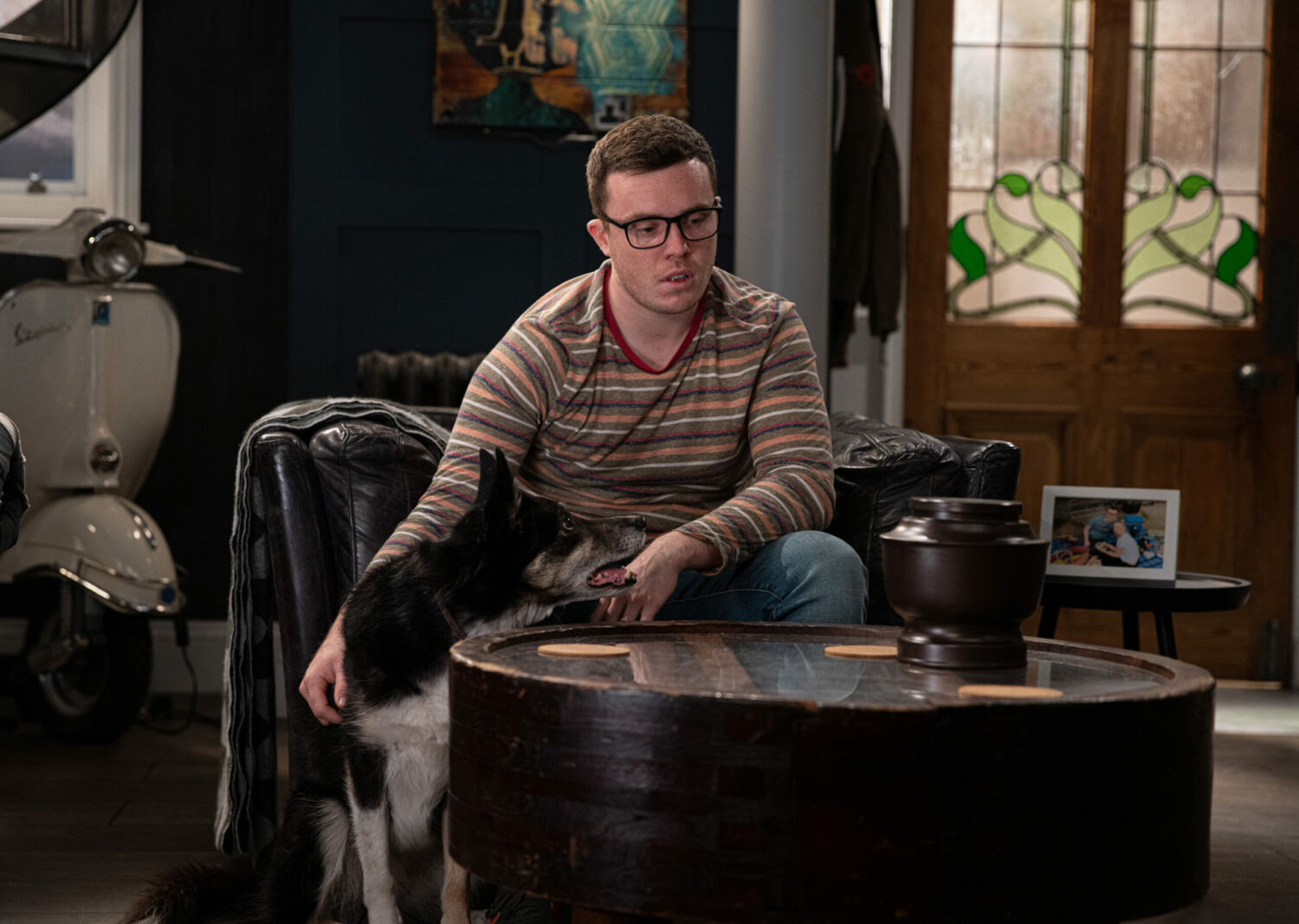 Vinny sits with his dog, Chip, looking sad