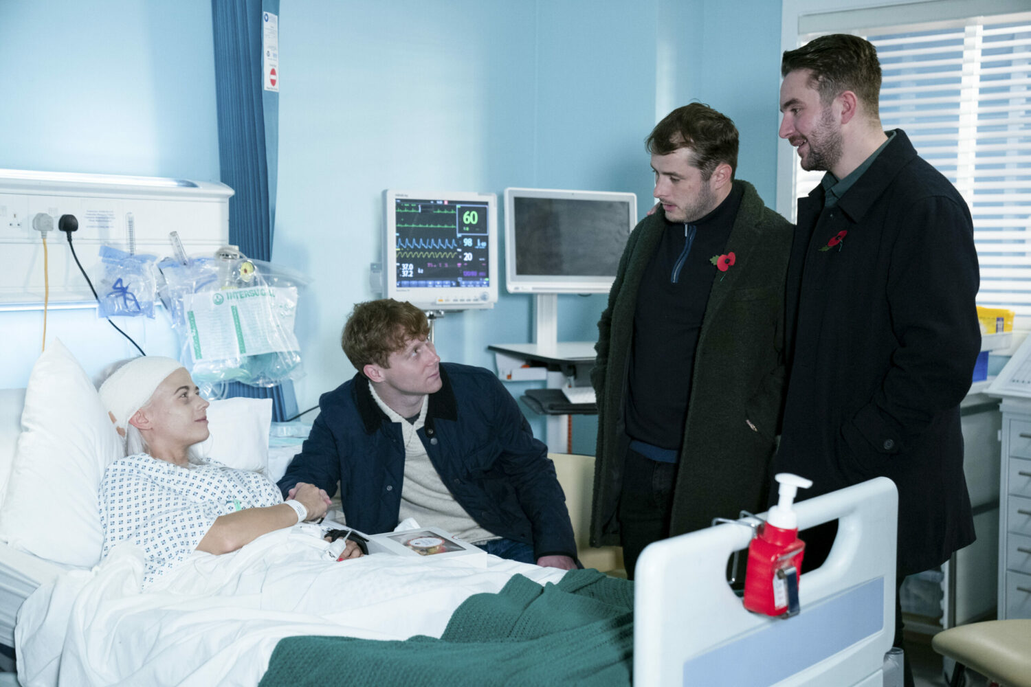 EastEnders' Lola in her hospital bed with Jay, Ben and Callum by her side