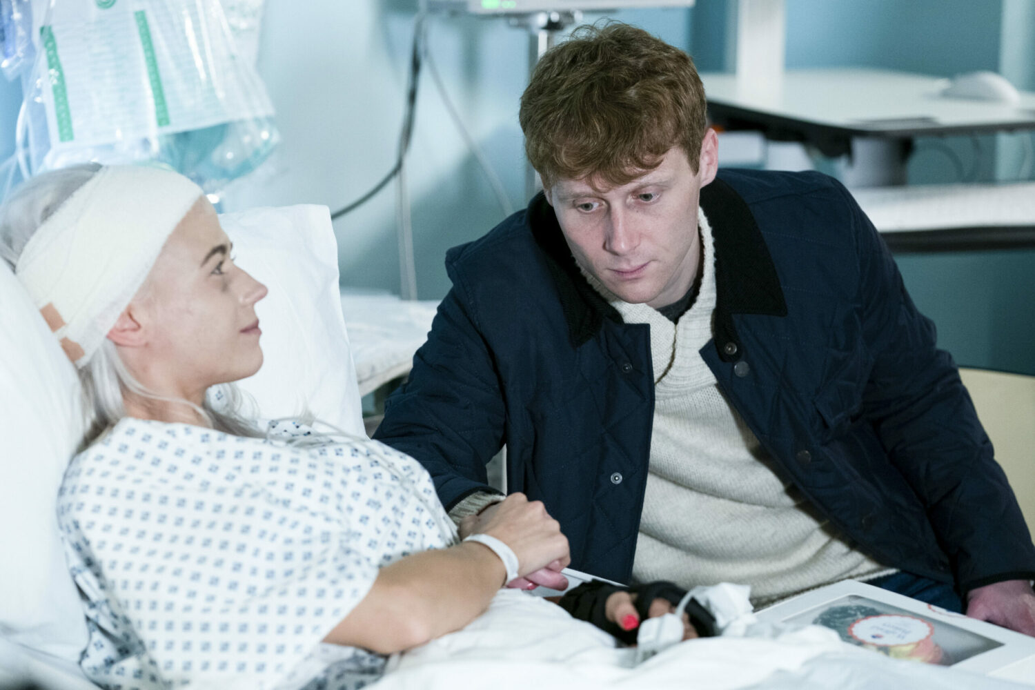 Jay Brown sits at the side of Lola Pearce's hospital bed after her brain surgery