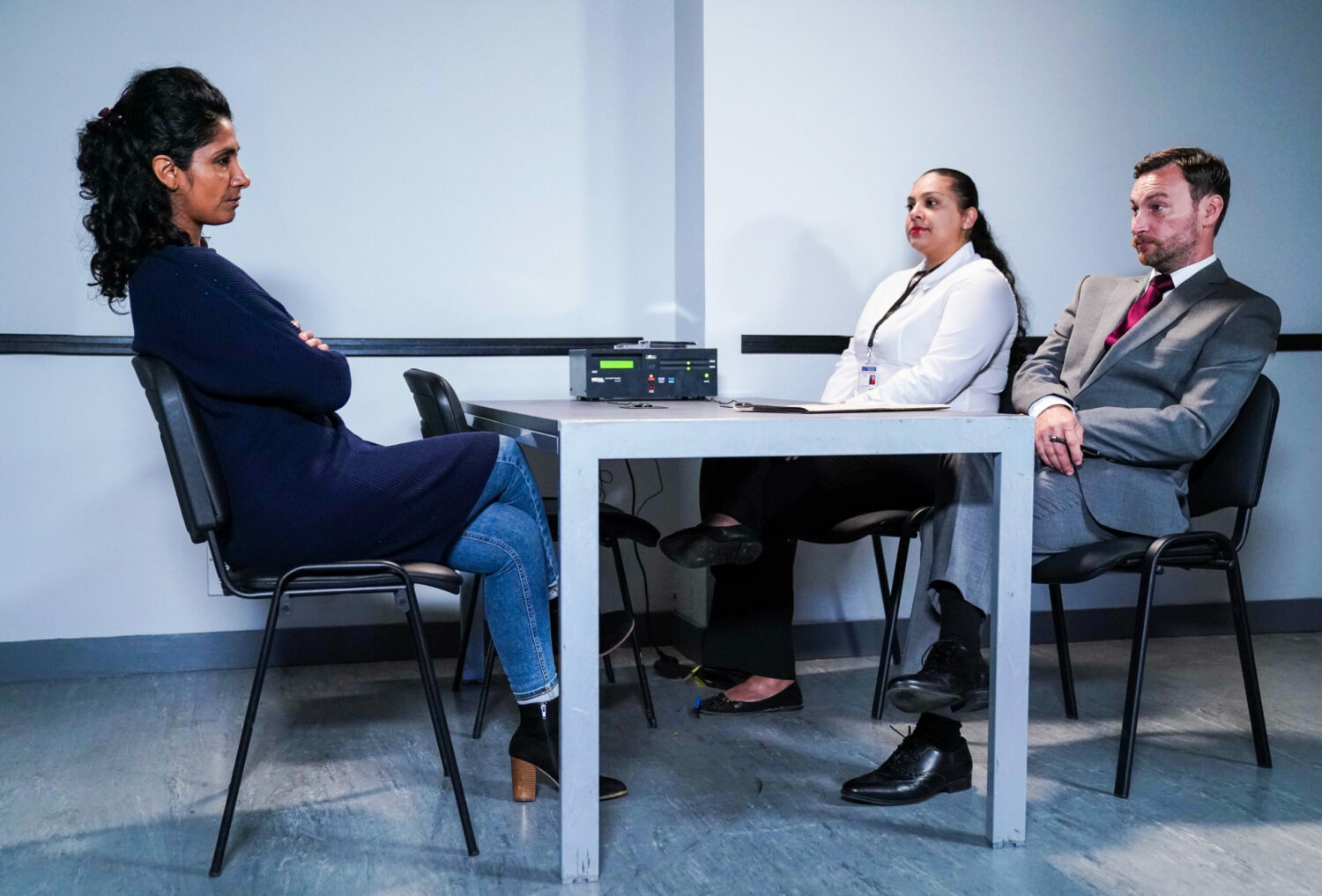 Suki questioned by two police officers in EastEnders