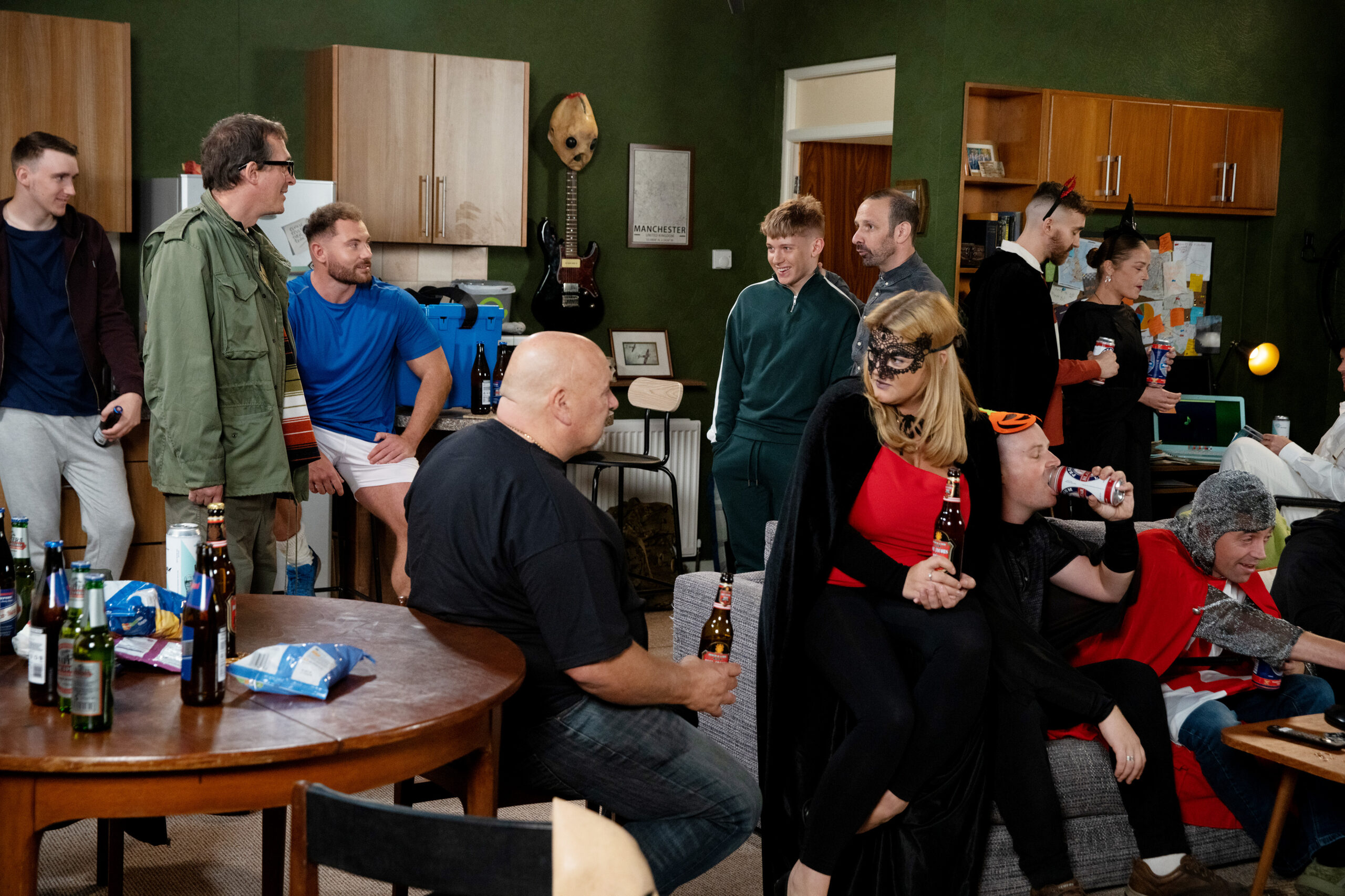 Spider in Corrie talks to Max and Griff at a crowded Halloween party