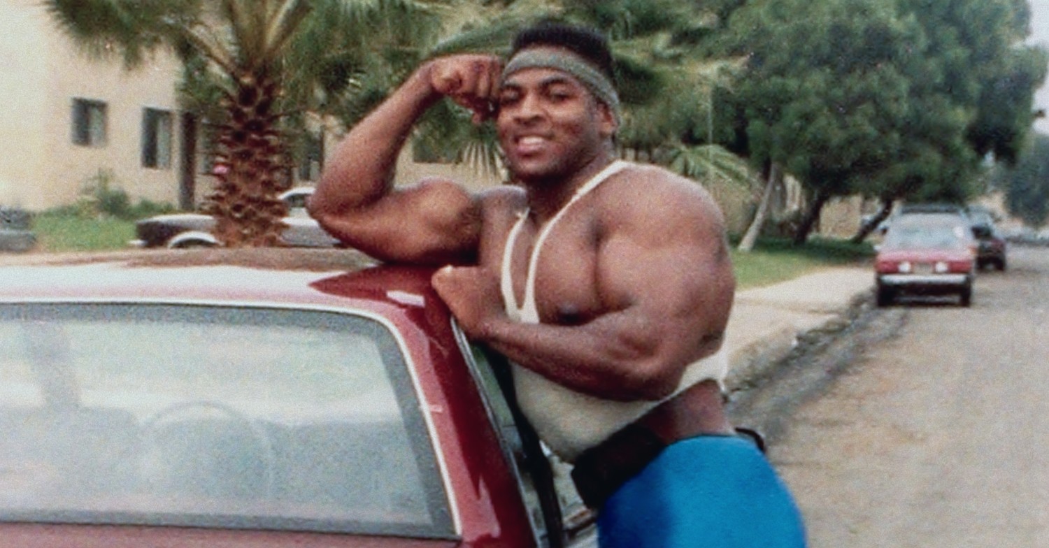 Ray McNeil posing by car in Killer Sally