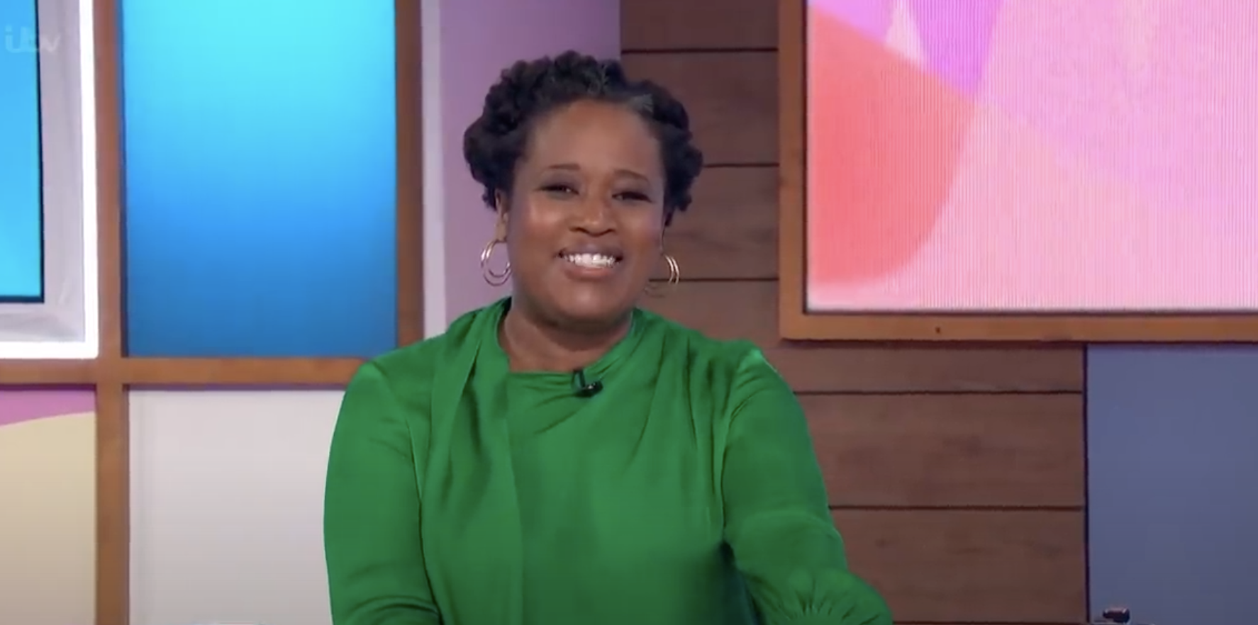 Charlene White smiling behind Loose Women desk