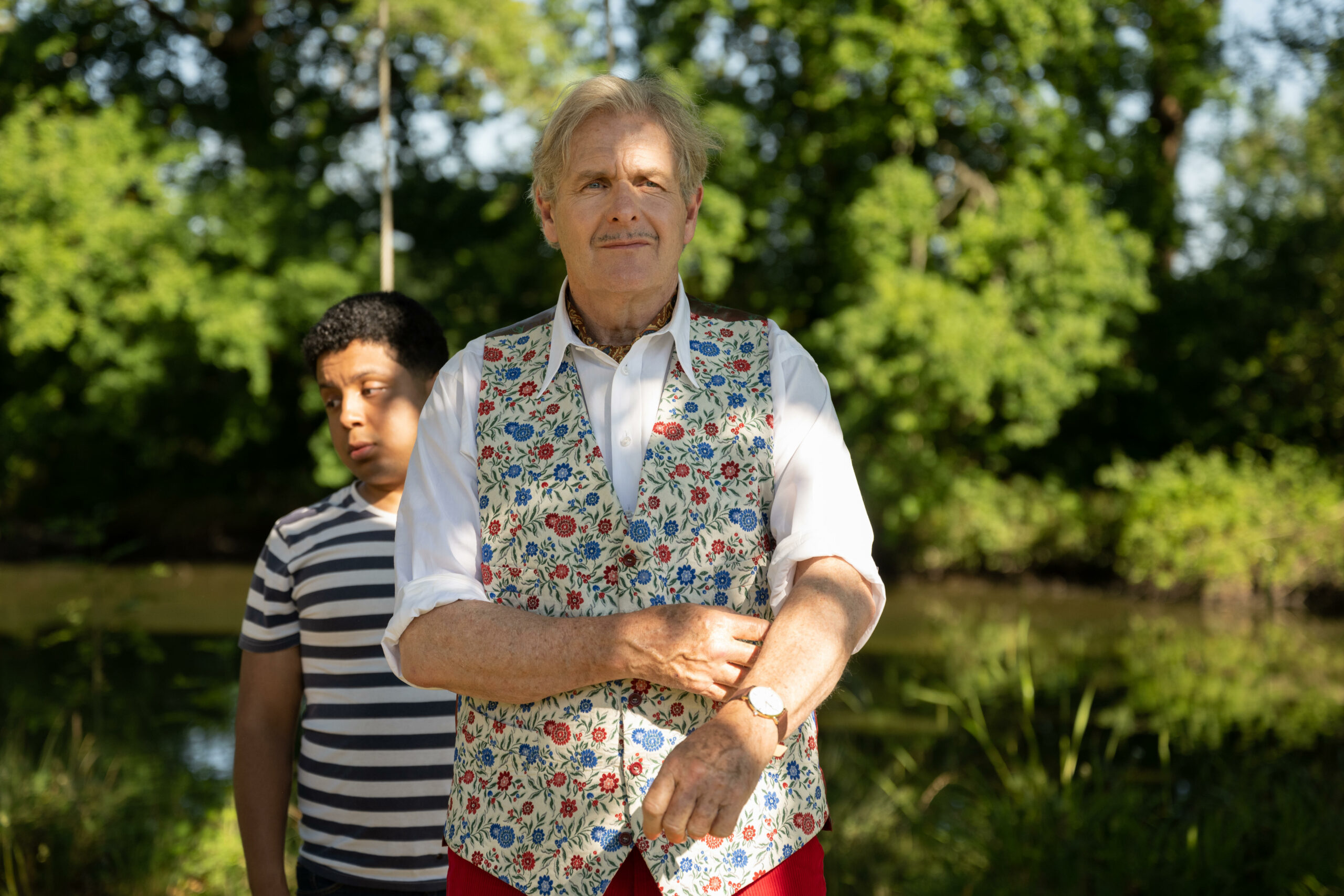 Johnny Delamere posing in the garden in The Larkins