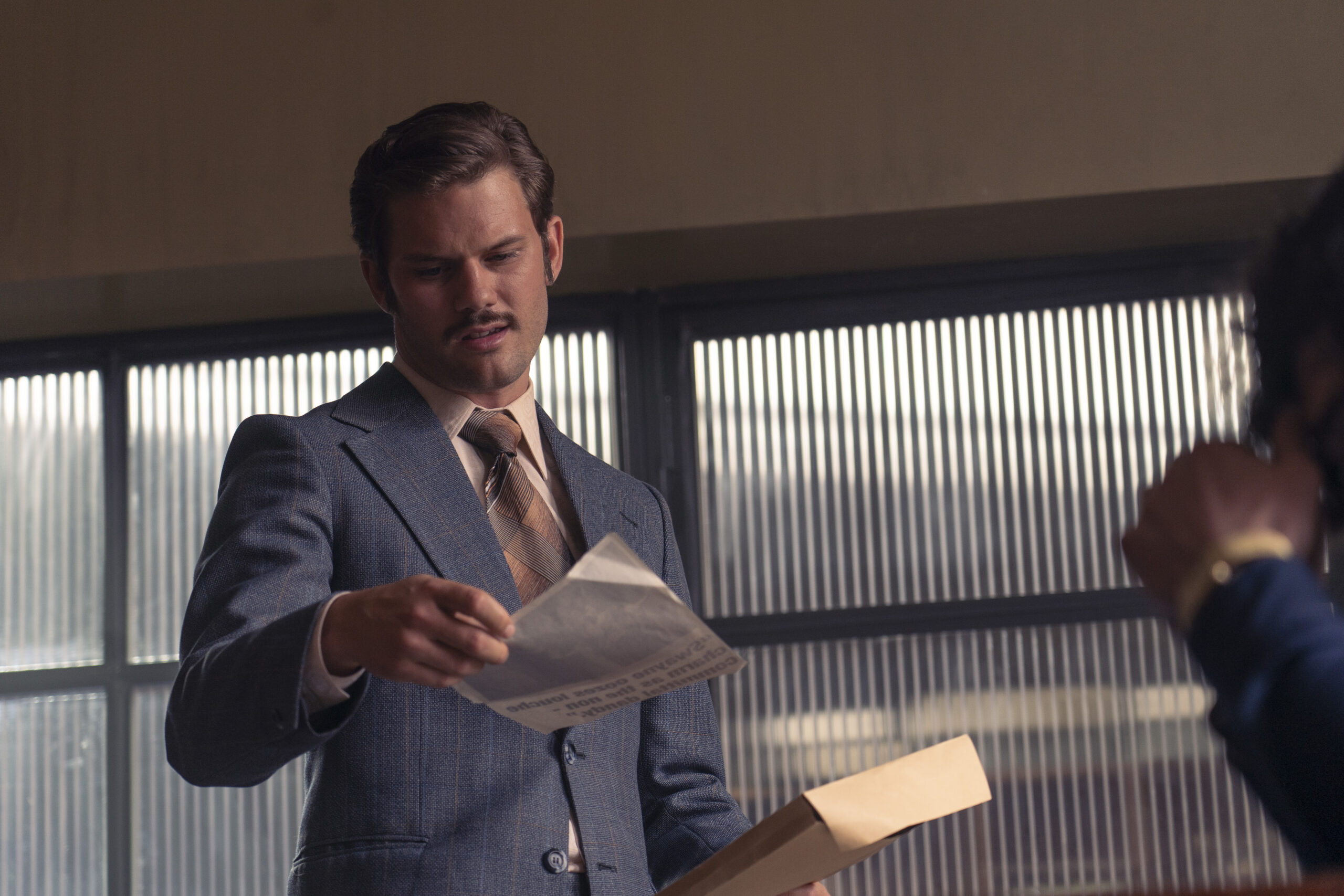 DS Charles Masterson reads from a paper in Dalgliesh