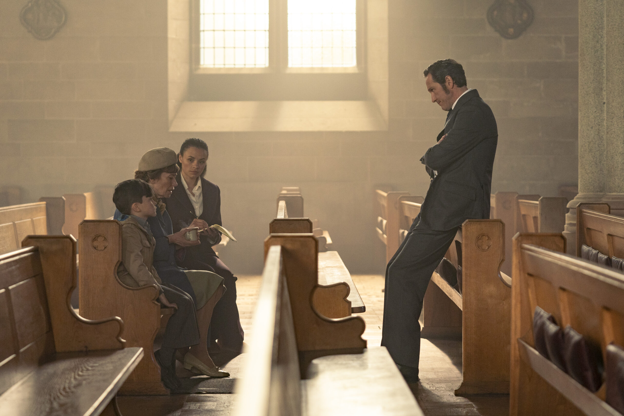 Dalgliesh talks to two people in a church