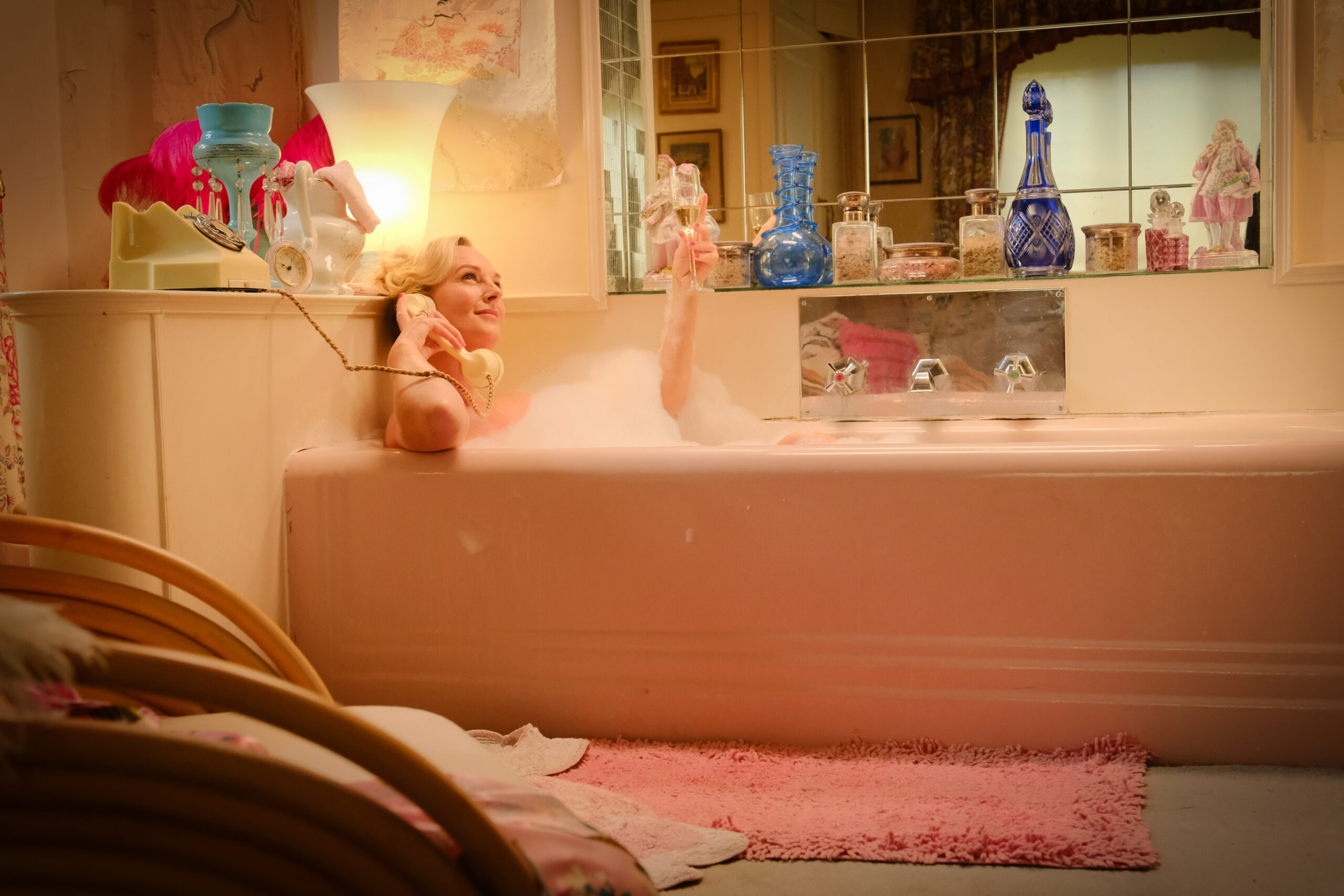 Katherine Kingsley sitting in the bath tub in The Larkins