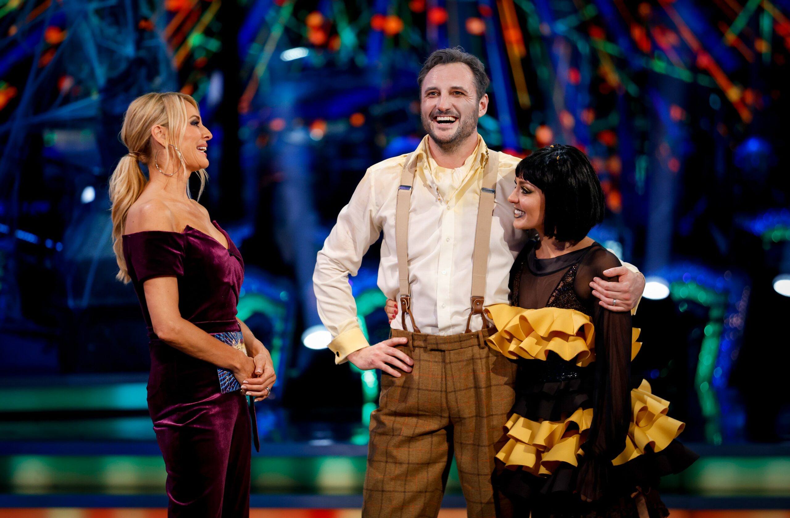 James Bye and Amy Dowden laughing as they speak to Tess Daly during Strictly results
