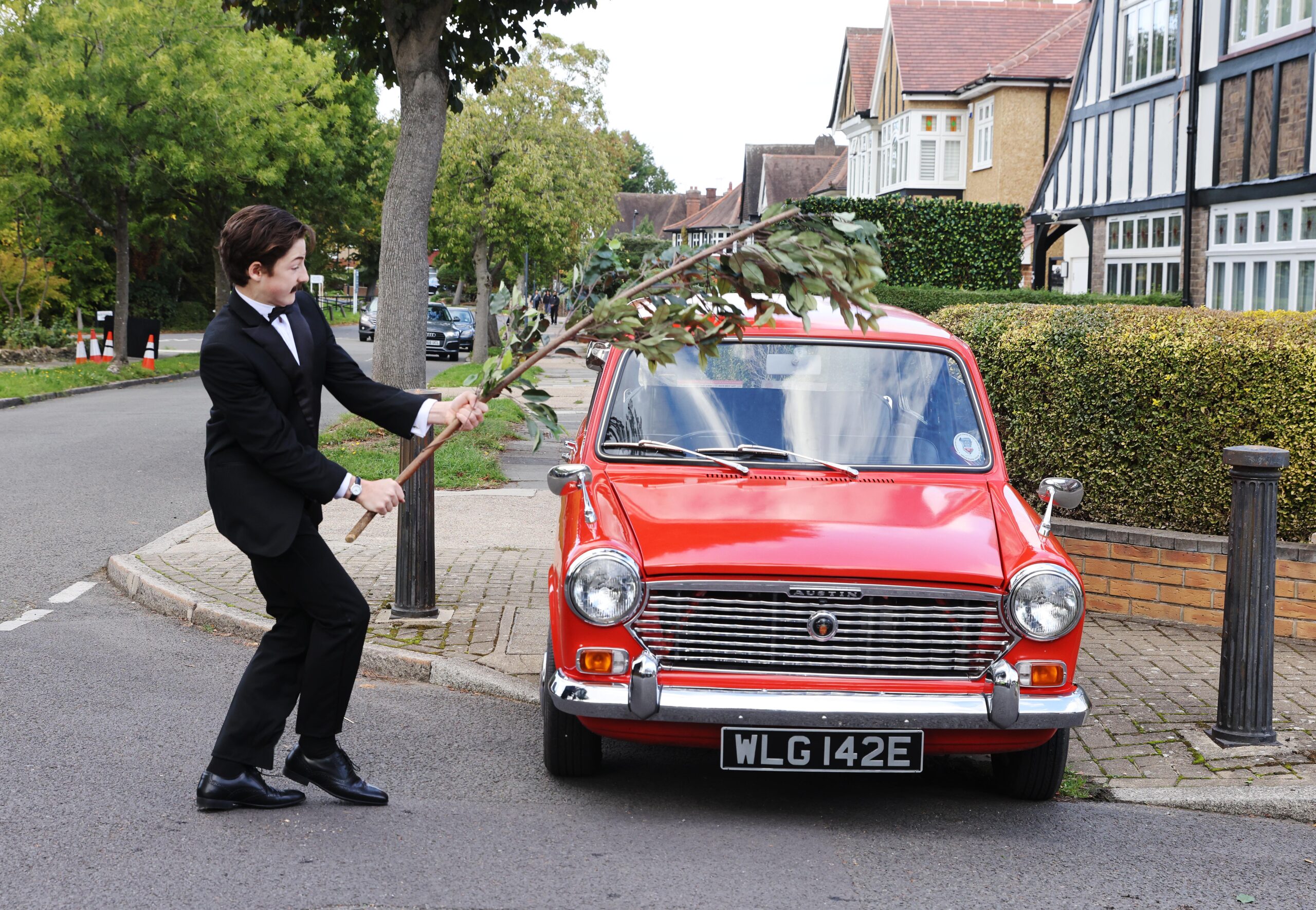 Kid whacking a car with a branch from Fawlty Towers