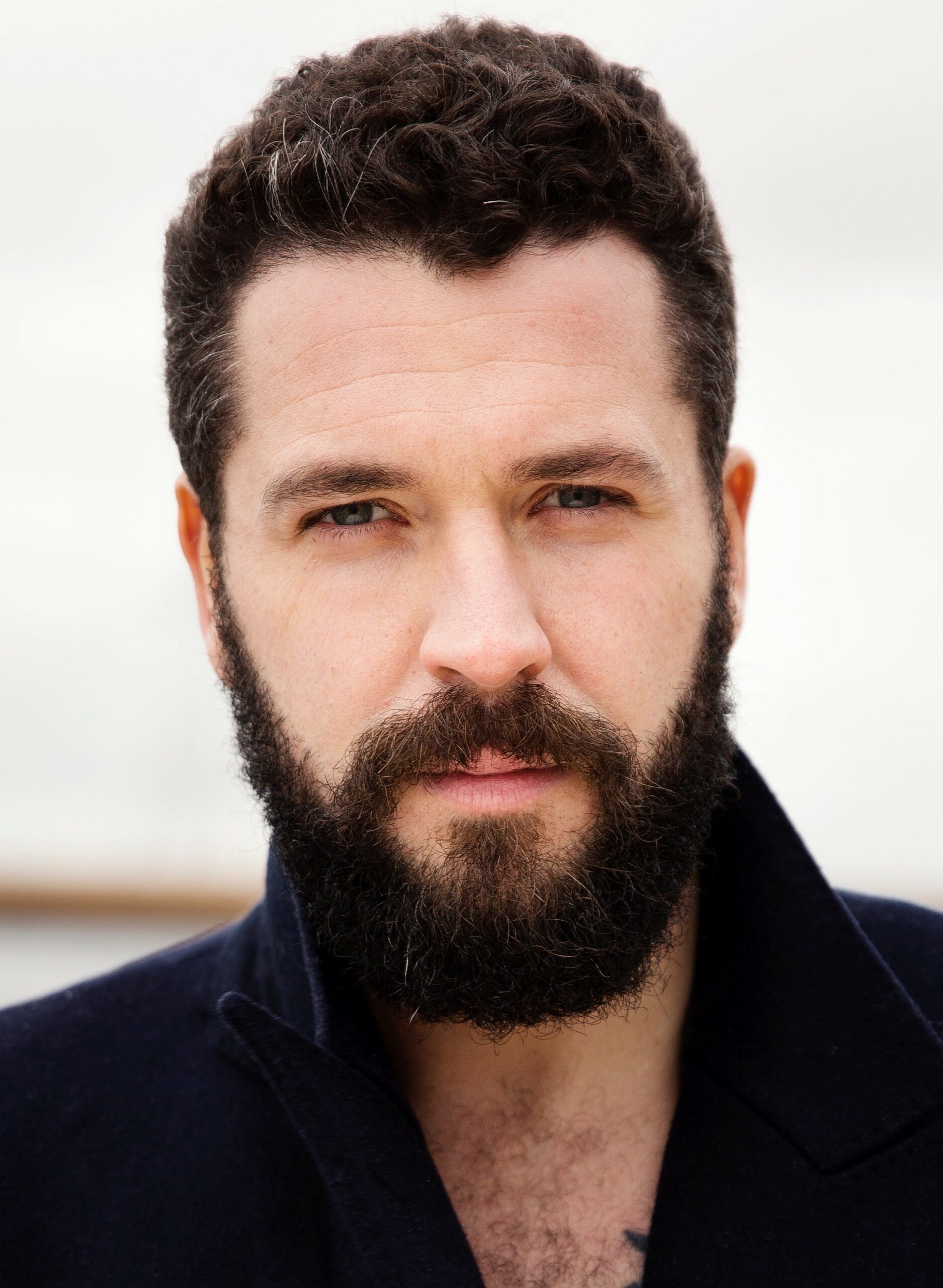 Shayne Ward looks straight into the camera with a full beard