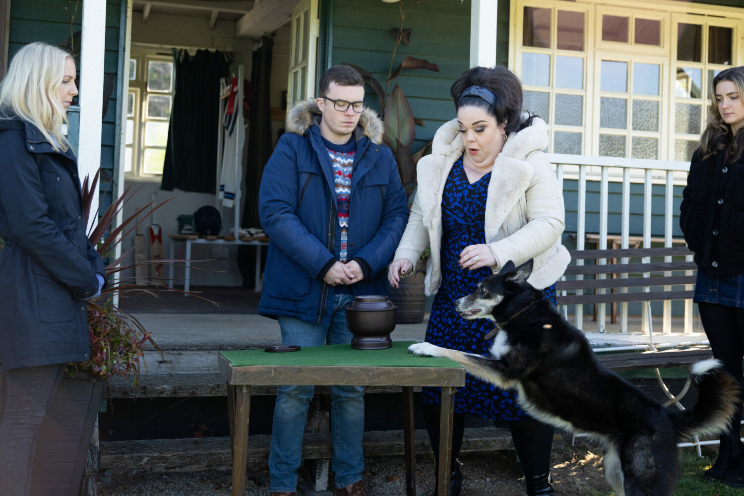 Mandy in Emmerdale looks shocked as Chip jumps up at the table with the urn on