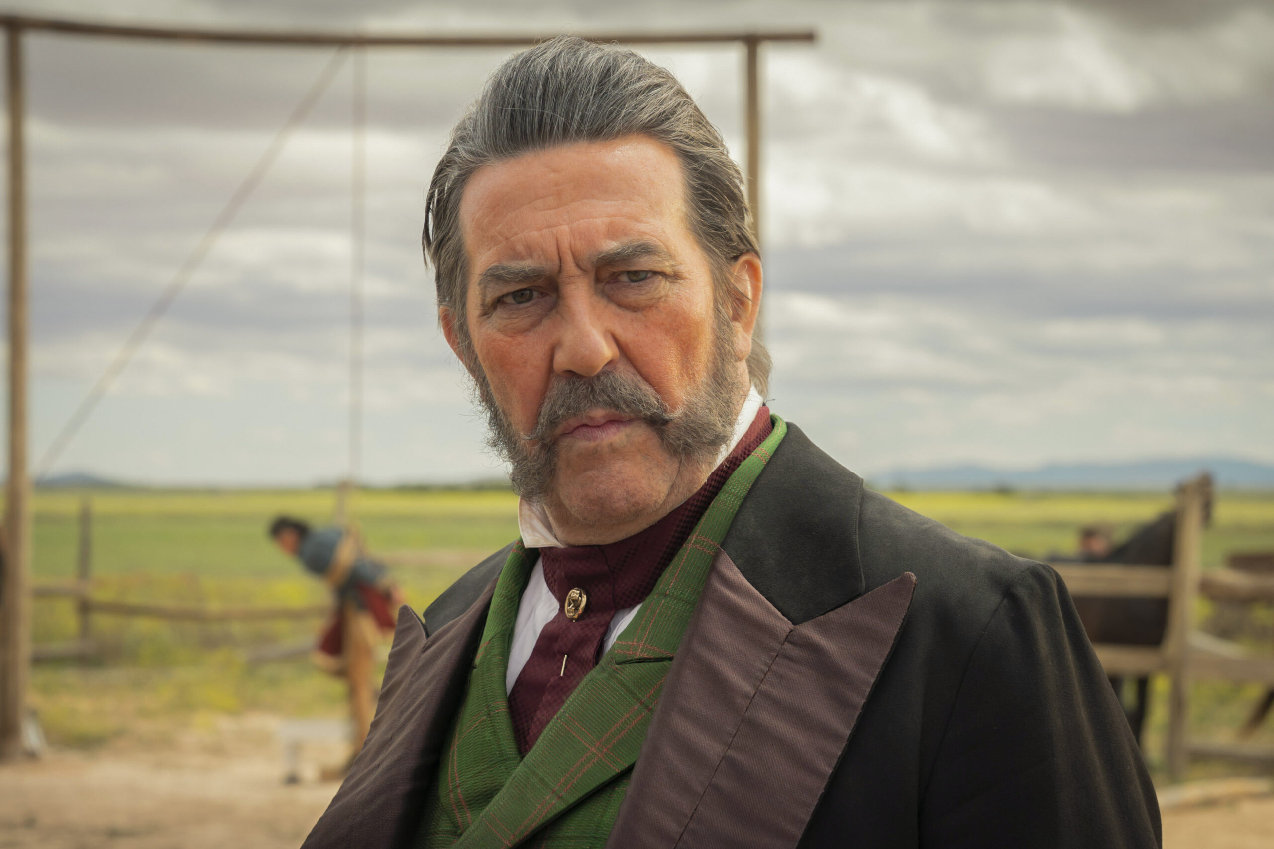 Richard Watts stares to his right in The English