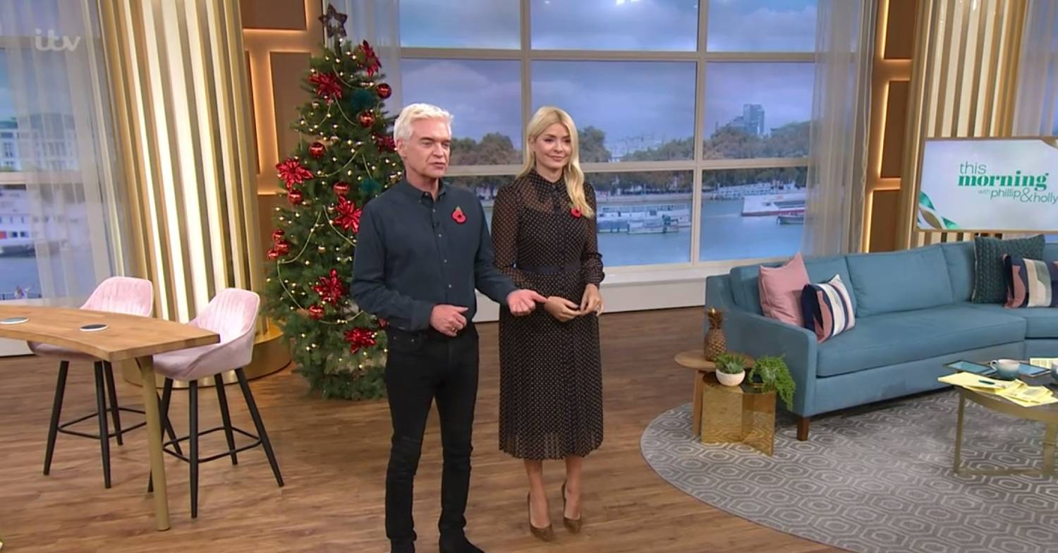 Phillip Schofield and Holly Willoughby stand in front of a Christmas tree in the This Morning studio today