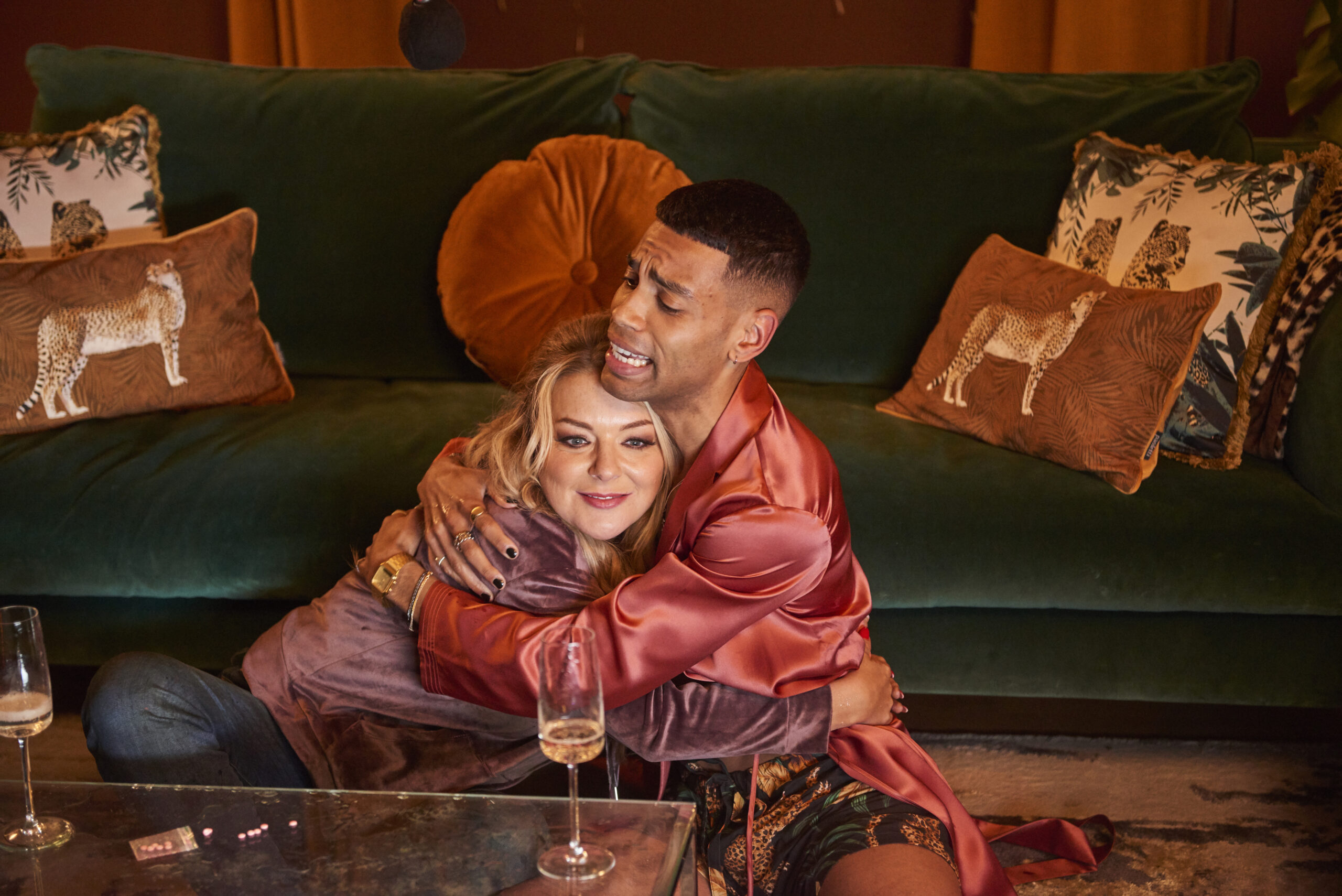 Rosie and Nico hug close on the floor