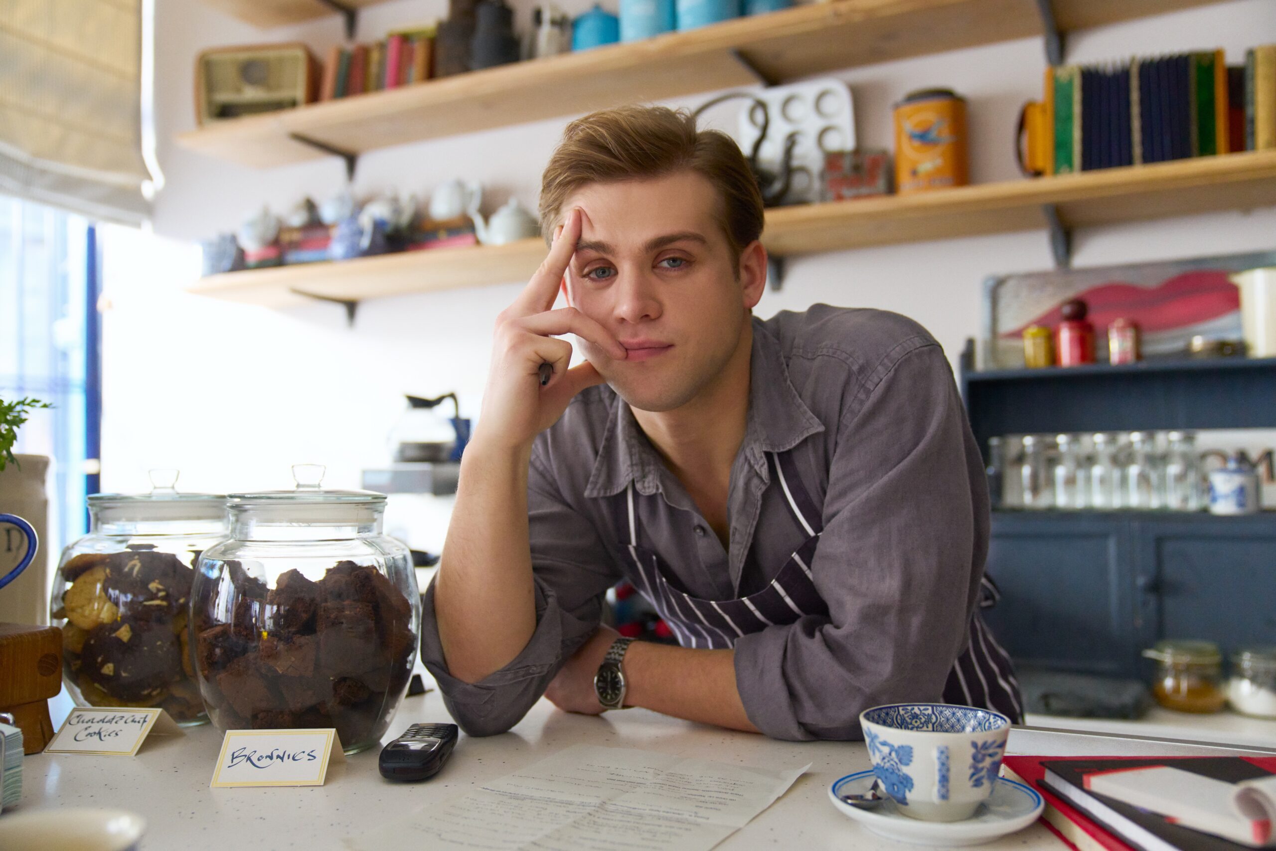 Leo Woodall leans on a counter for One Day
