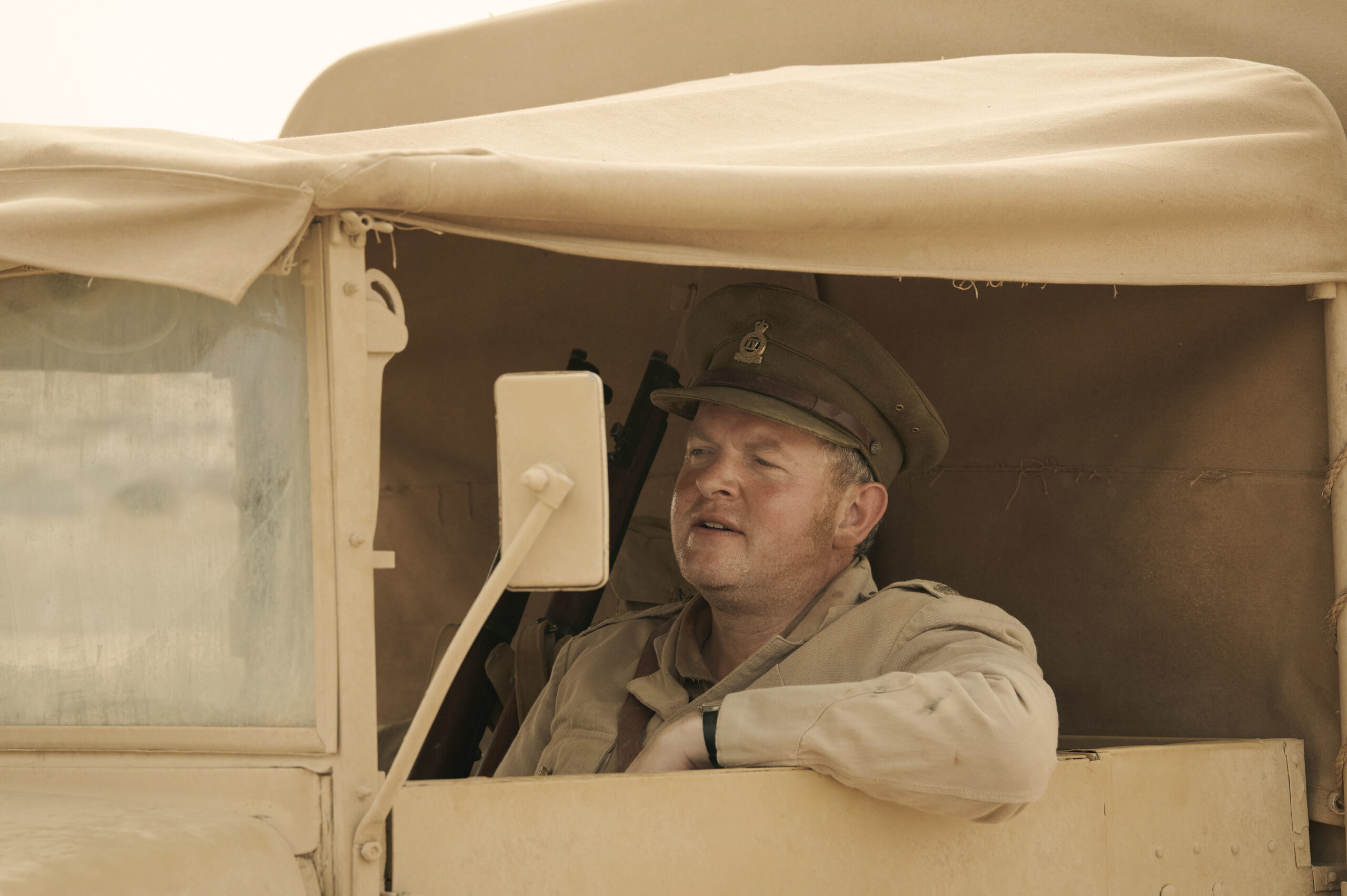 Miles Jupp driving a jeep in SAS Rogue Heroes 