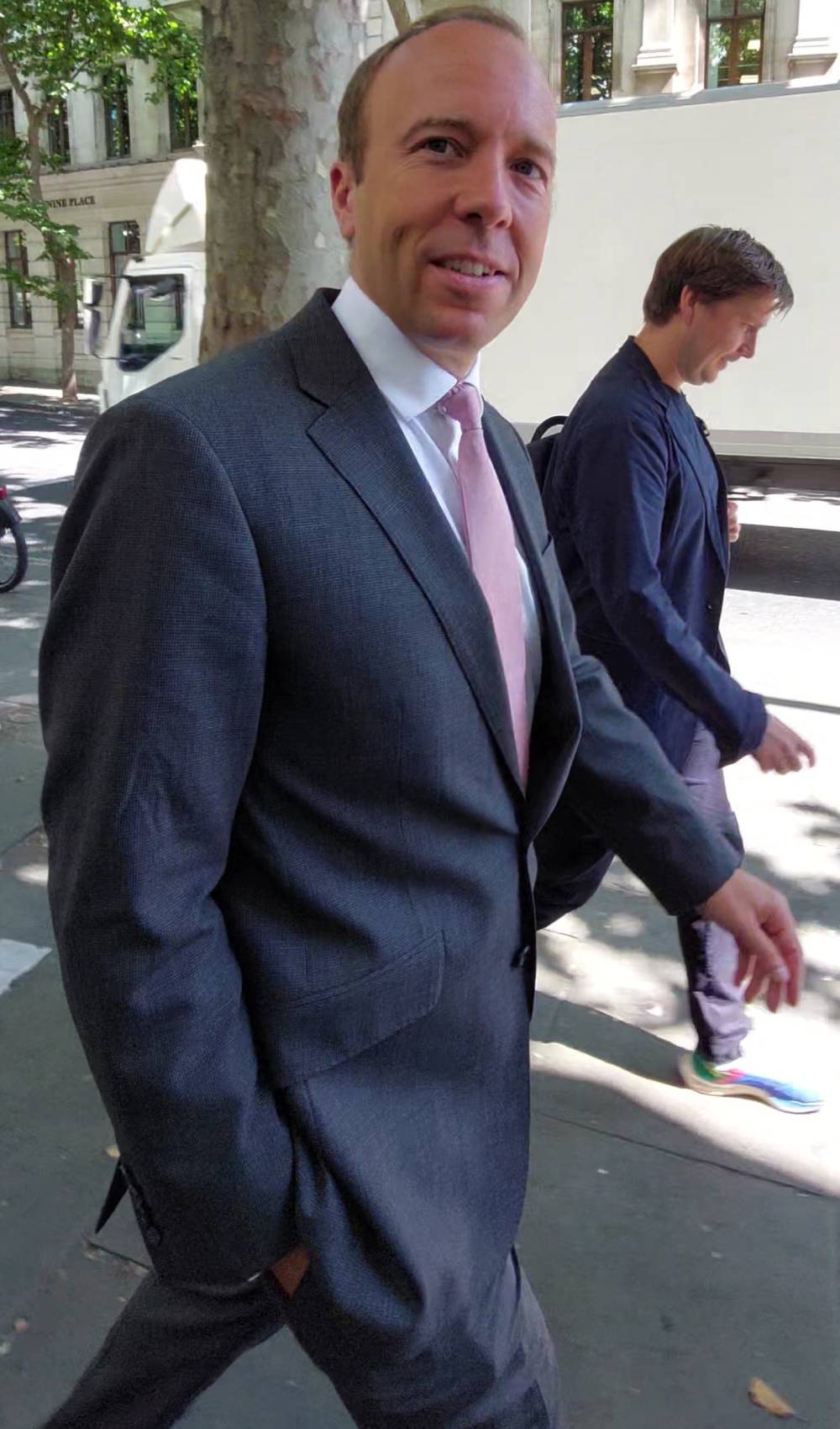 Matt Hancock walks down a street