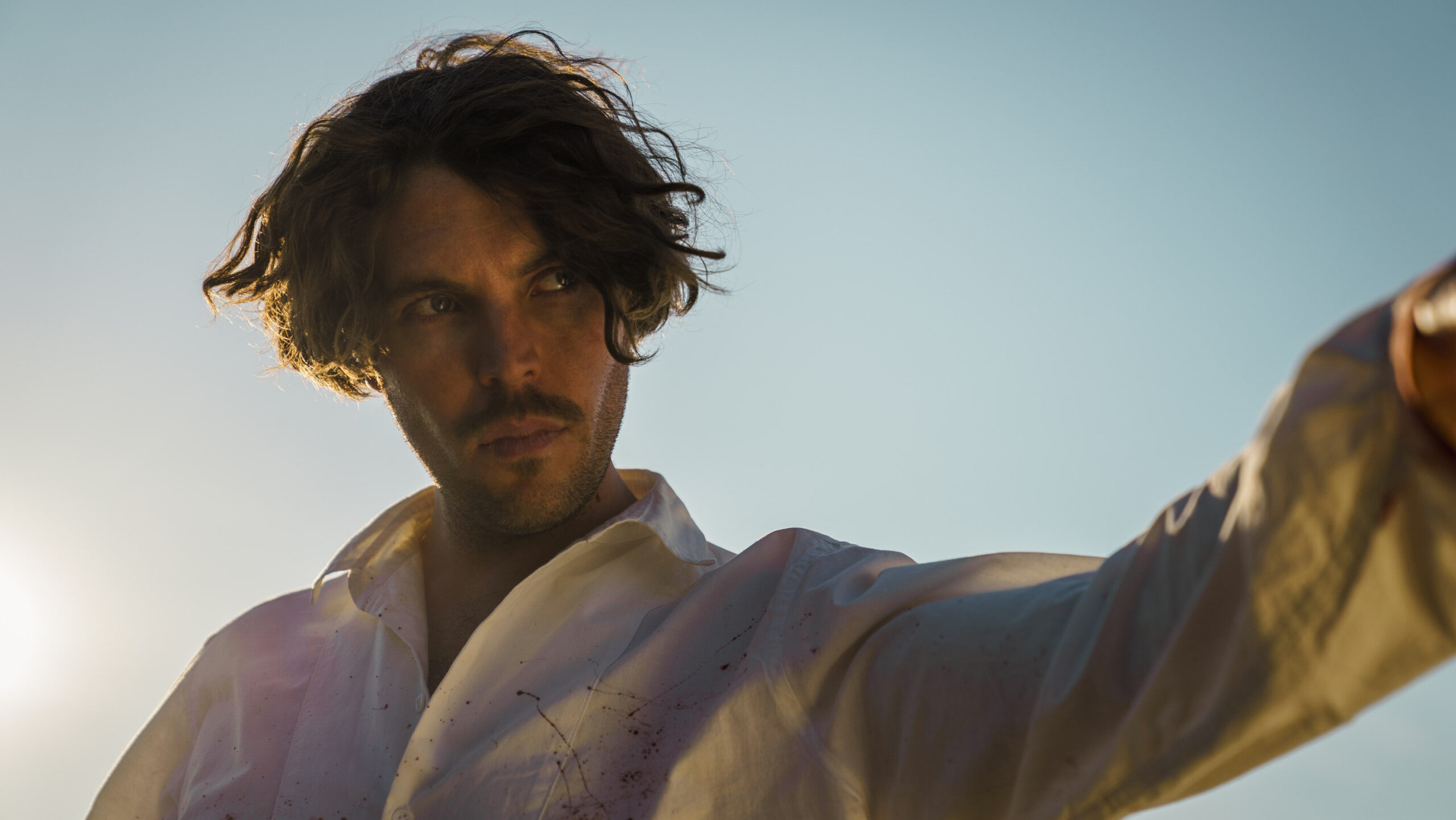 Thomas Trafford points up to the sky in The English