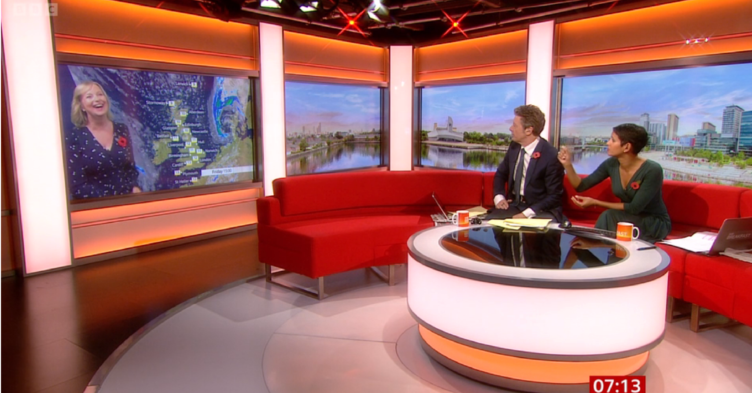 Carol Kirkwood laughing on a screen as Charlie Stayt and Naga Munchetty speak to her on BBC Breakfast today