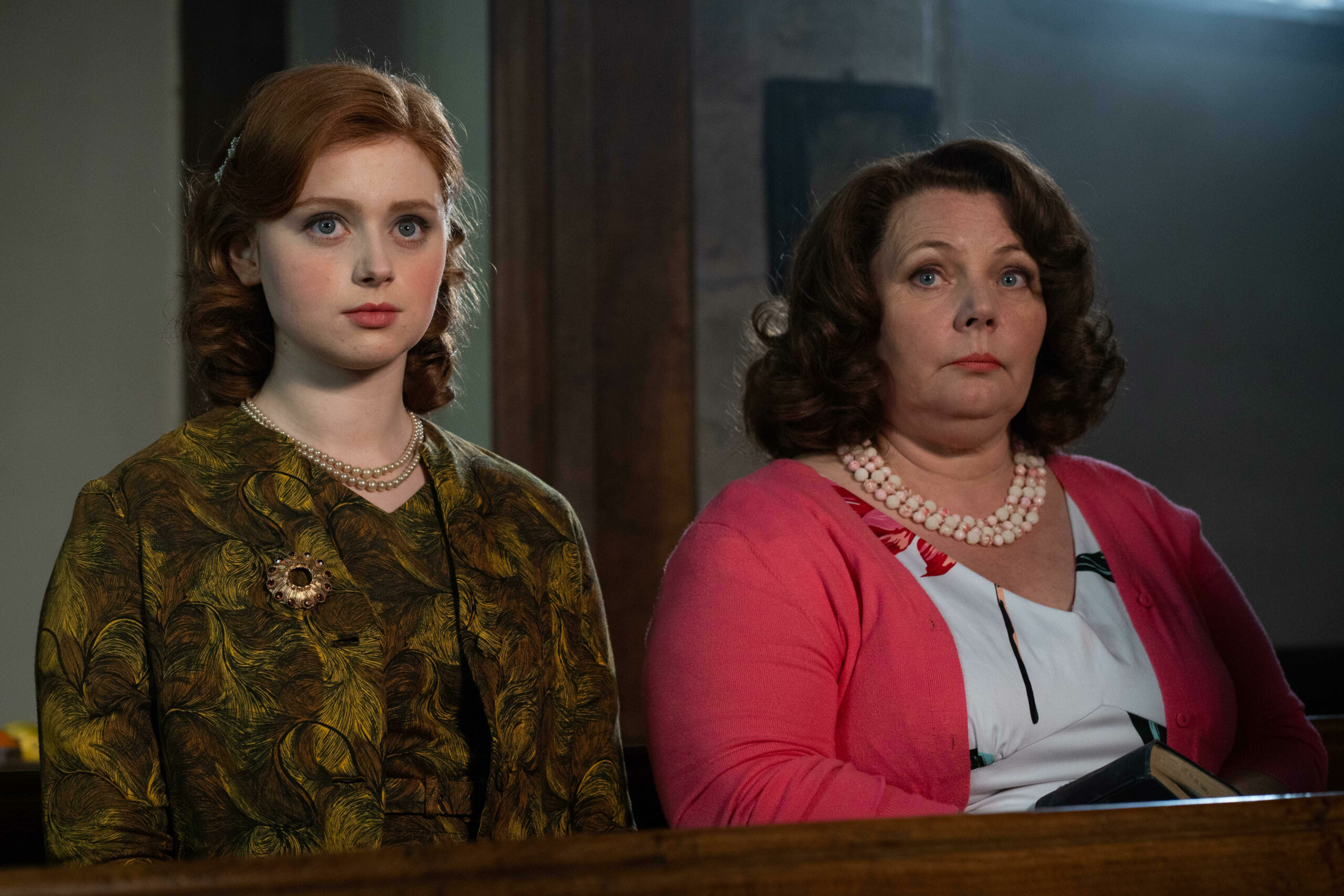 Lydia Page and Joana Scanlan sitting in church in The Larkins