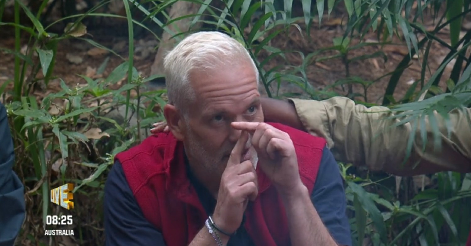 Chris Moyles making the letter T with his fingers on I'm A Celebrity 
