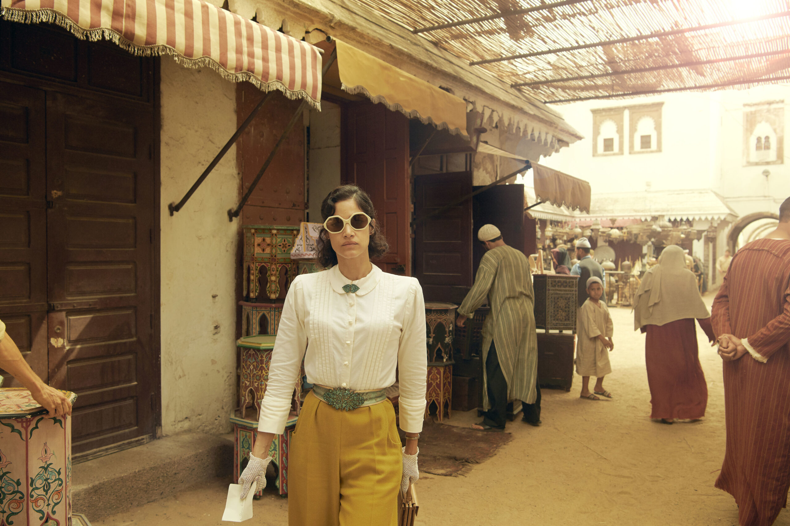 Sofia Boutella wearing yellow trousers in SAS Rogue Heroes 