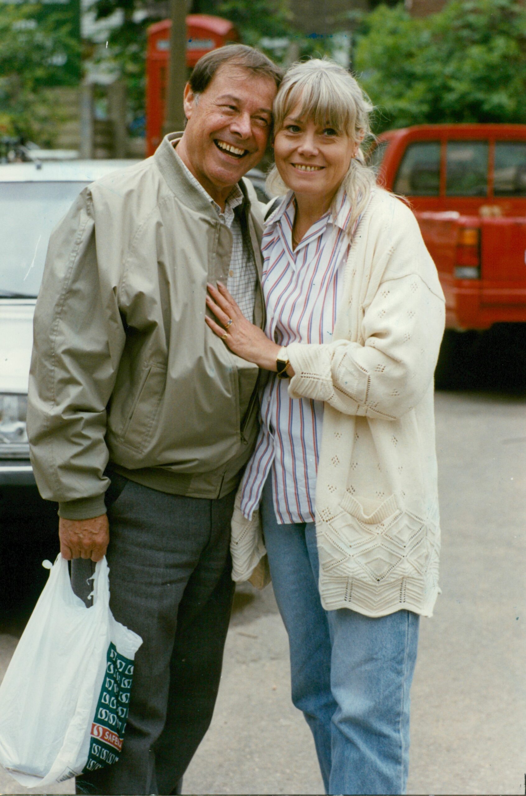 Arthur and Pauline Fowler in EastEnders smile as they are photographed together