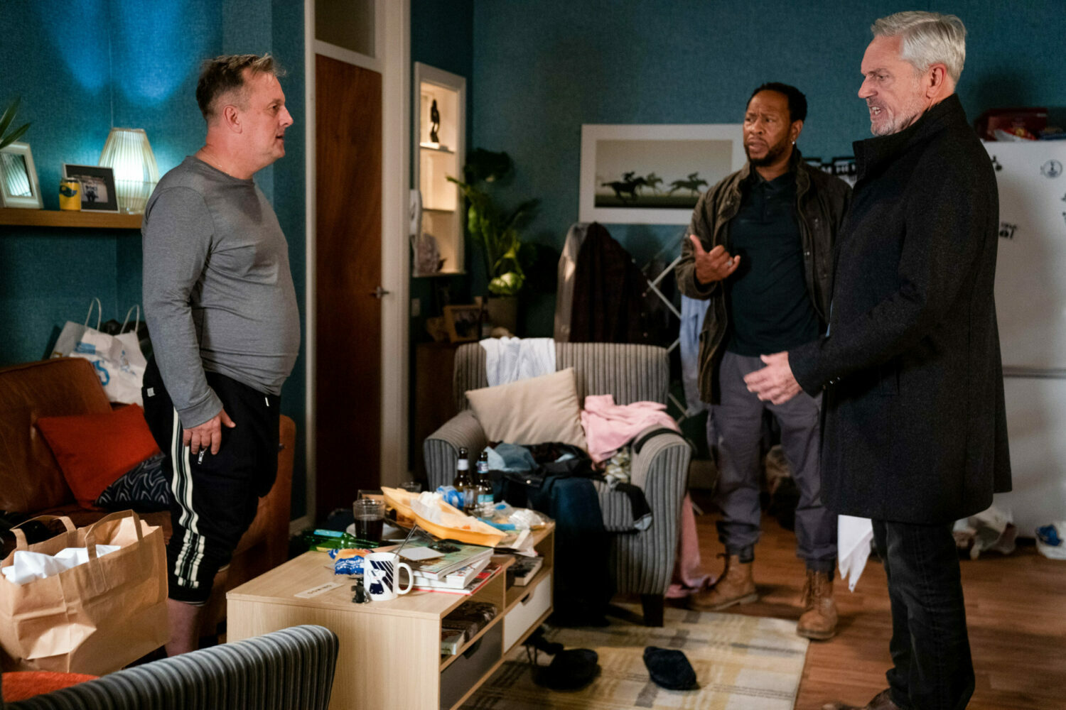 Rocky and Mitch talk to Freddie in his filthy flat (Credit: BBC)