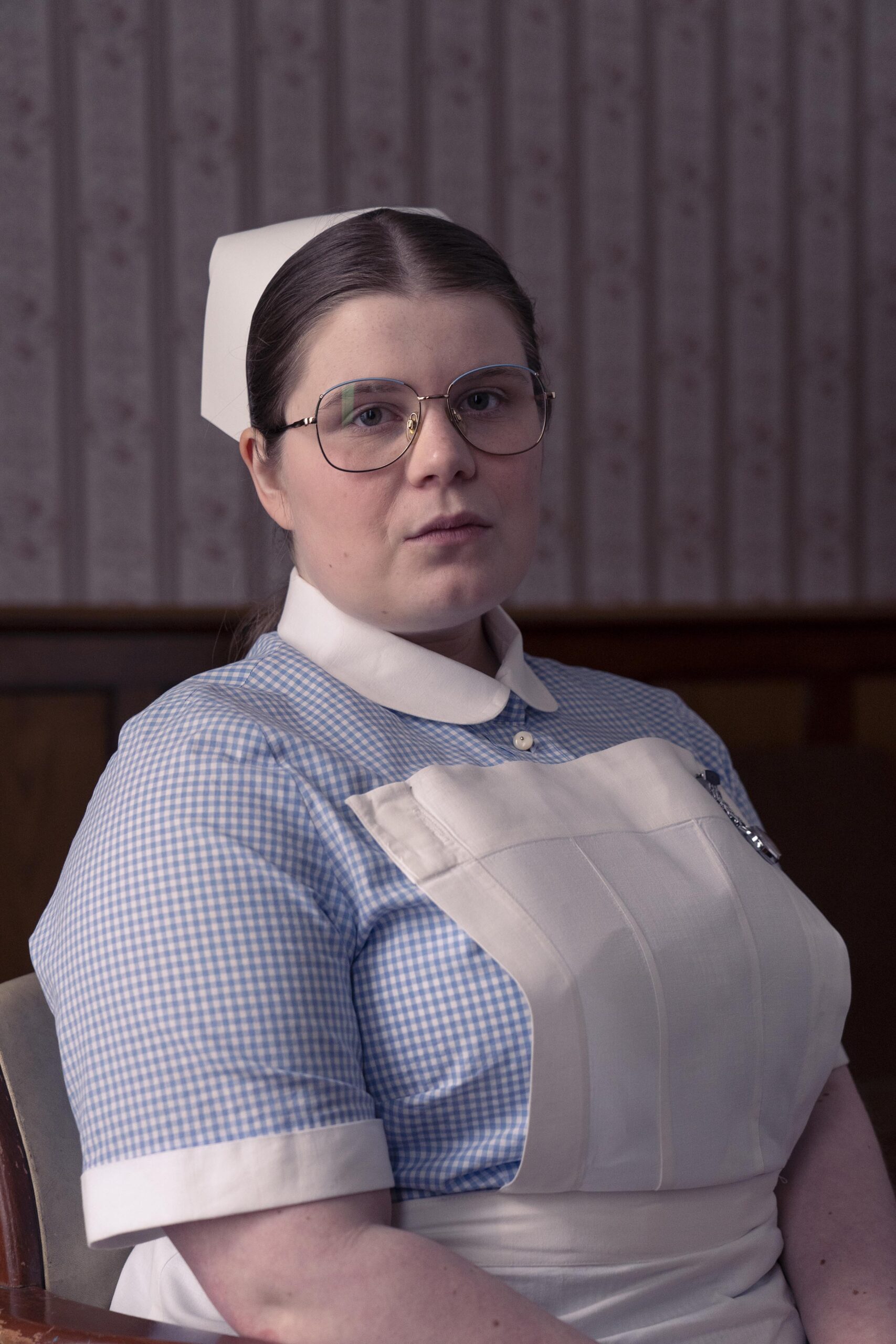 Madeline poses in a nursing uniform in Dalgliesh