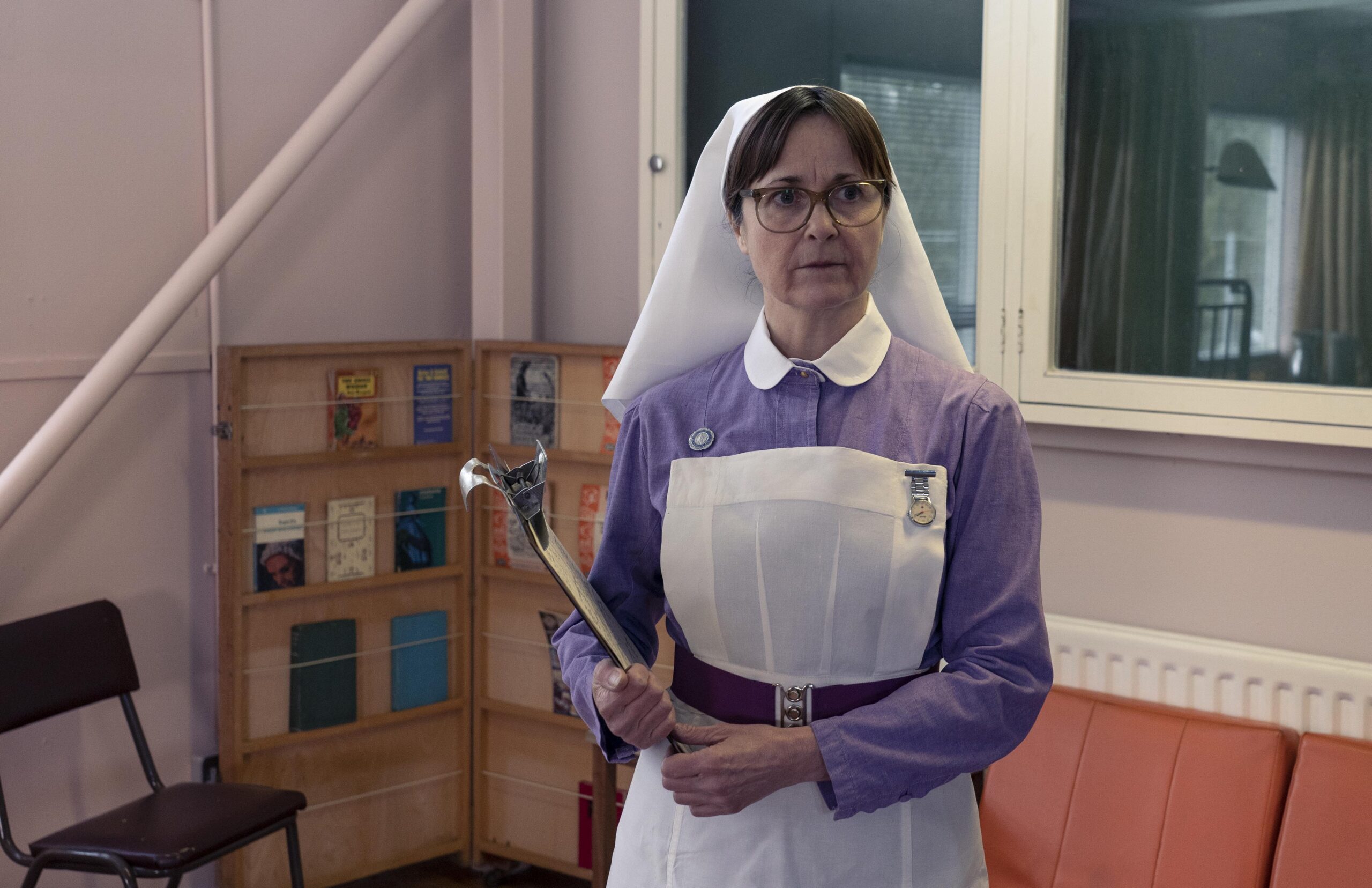 SIster Ethel holds a clipboard with a stressed expression