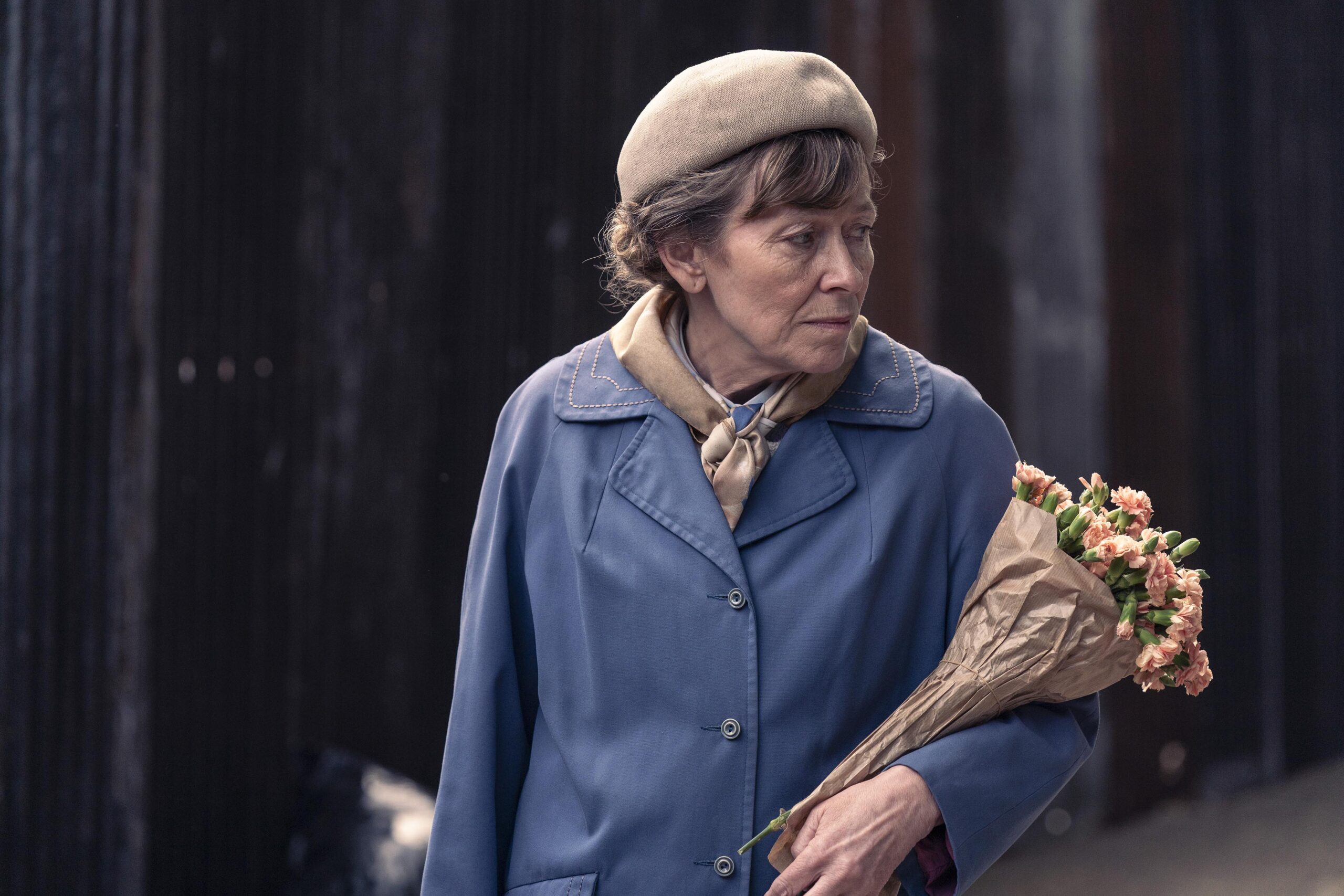Emily Wharton holds flowers on a street in Dalgliesh