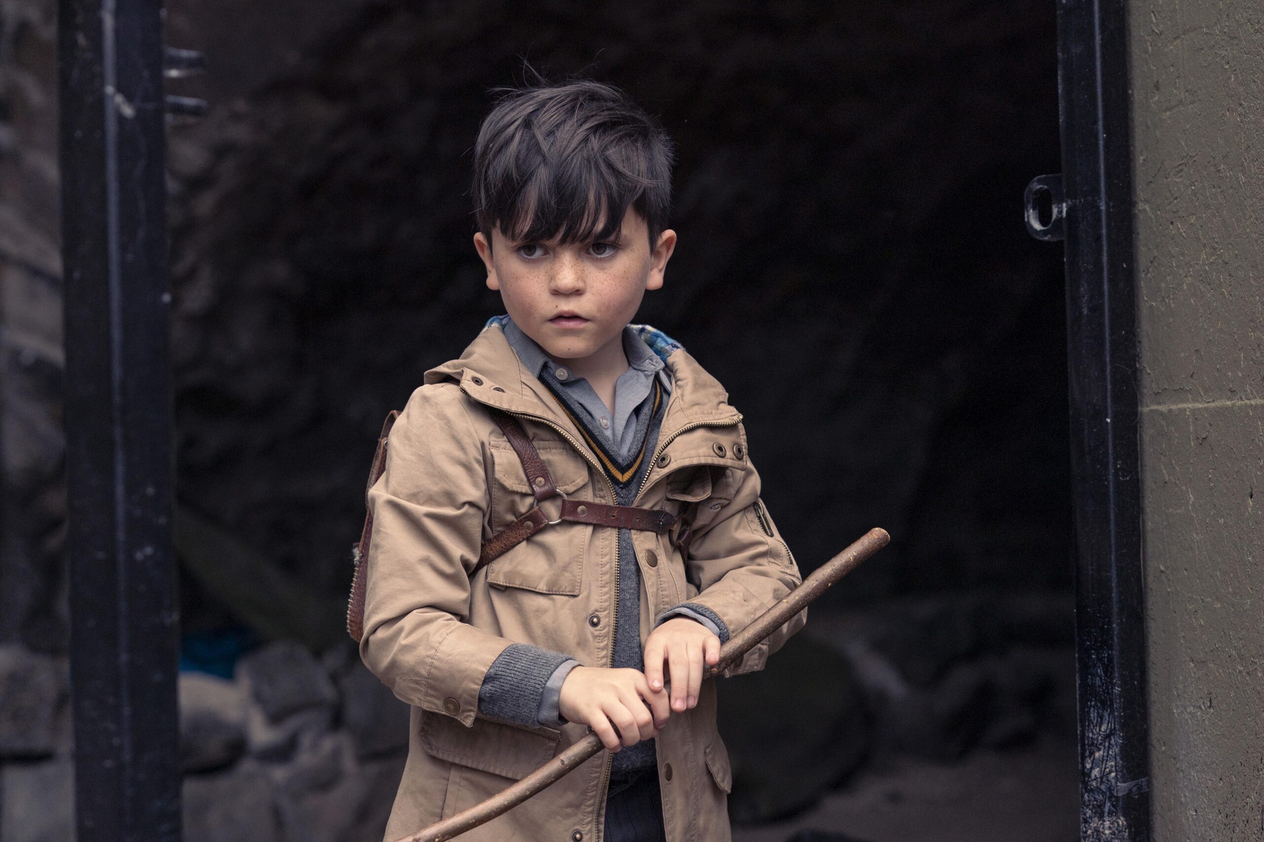 Darren holds a stick outside in Dalgliesh
