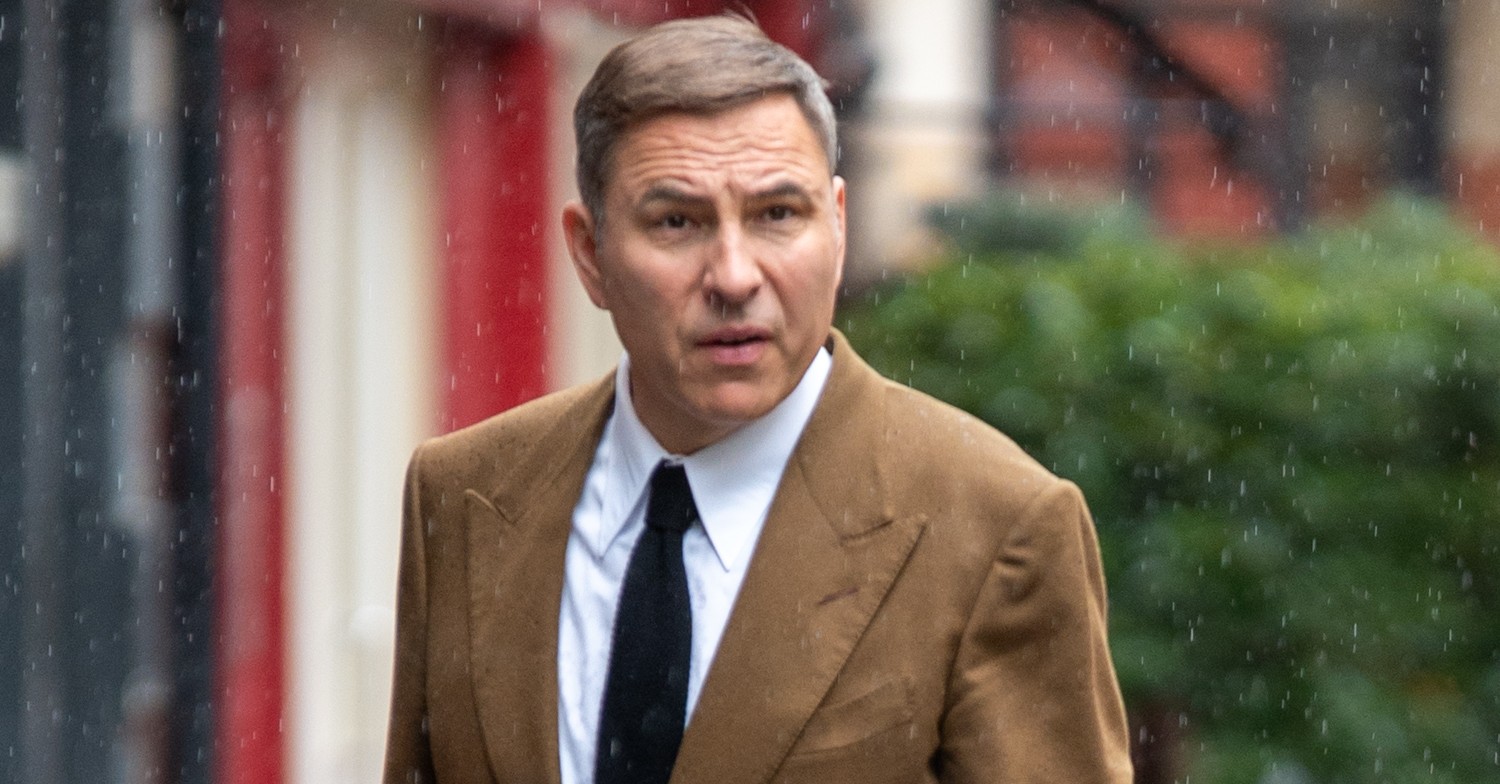 BGT judge David Walliams looking serious as he's caught in rain