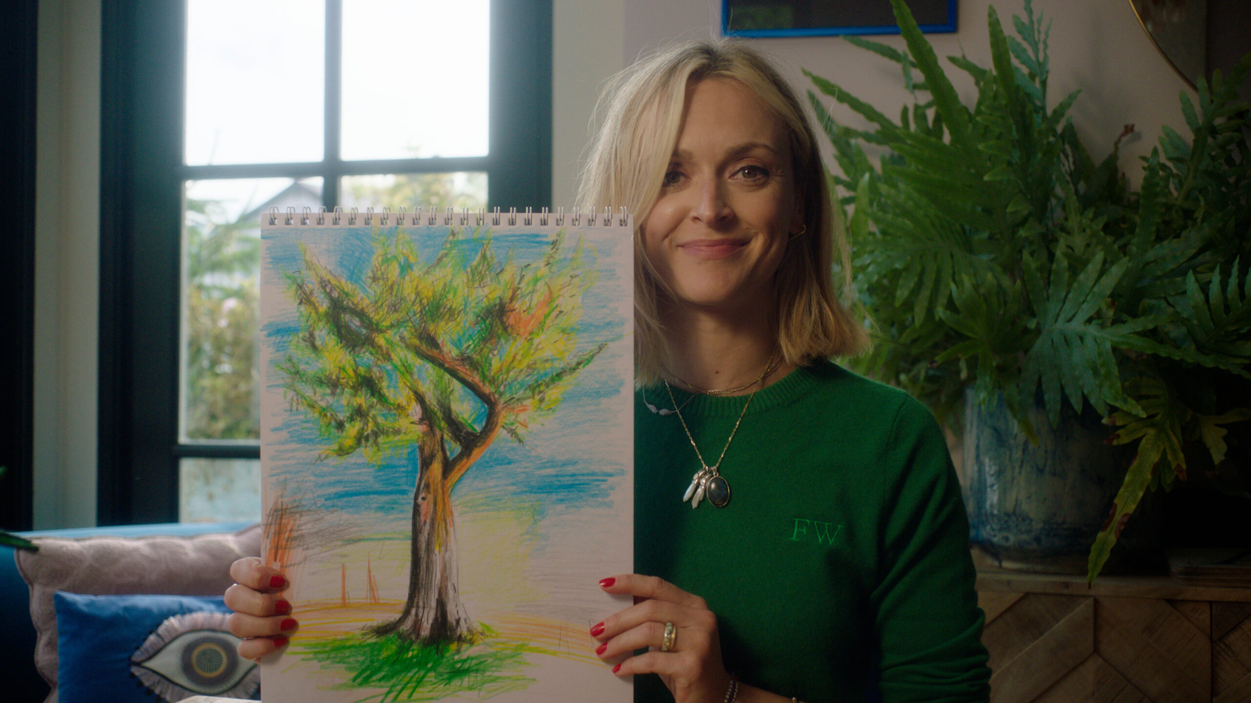 Fearne Cotton smiling and holding a painting