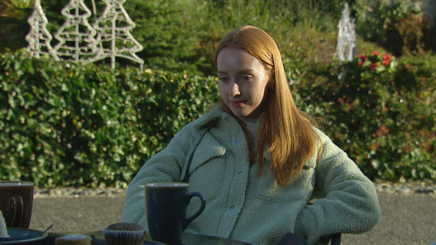 Emmerdale's Chloe is smiling outside of the café