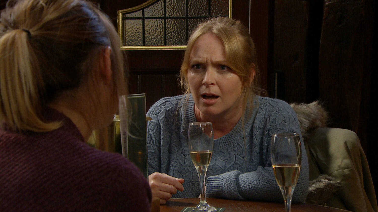 Vanessa stares angrily and shocked at Rhona in the pub in Emmerdale