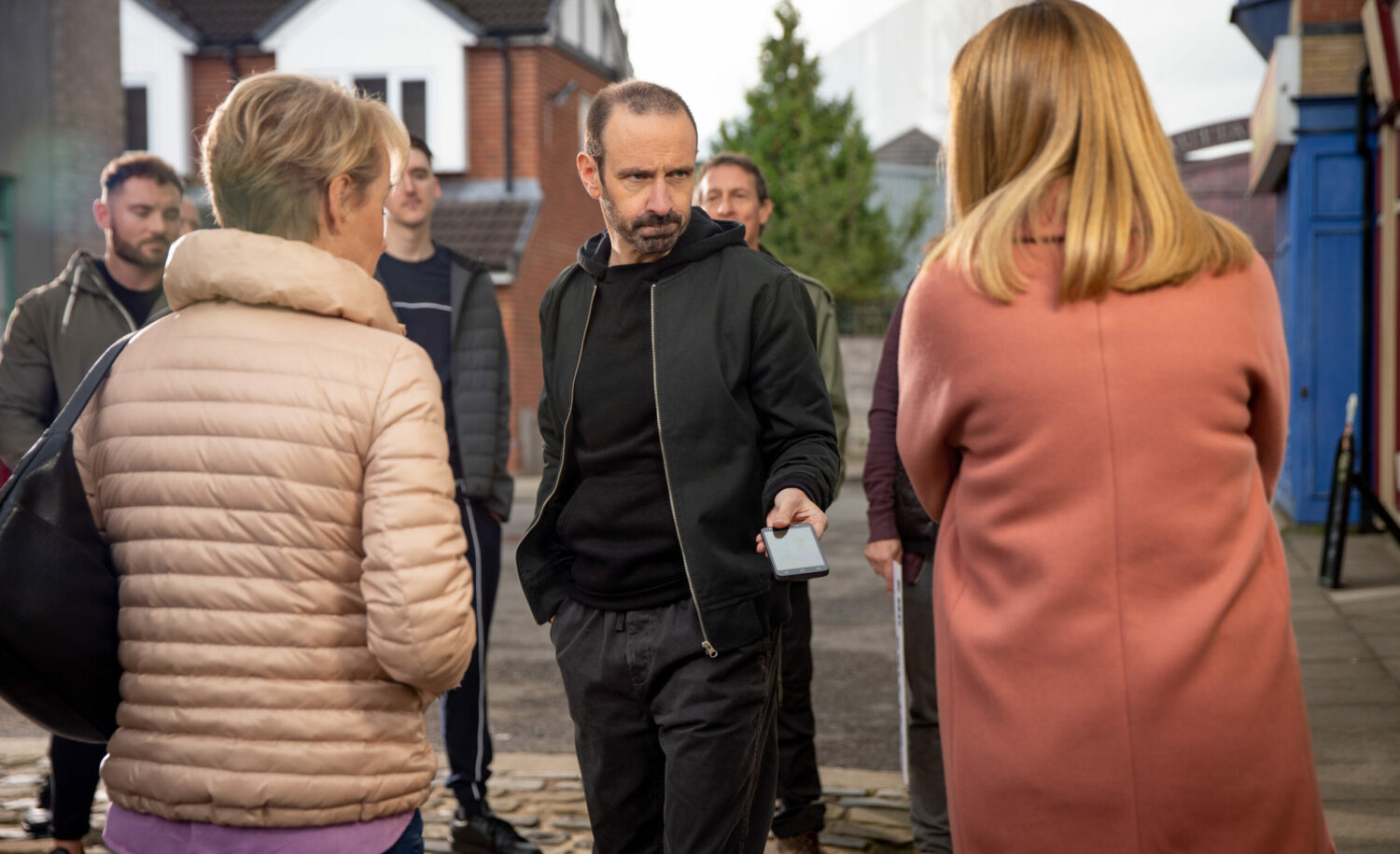 Griff and his gang are looking angrily towards Maria and Sally in Coronation Street