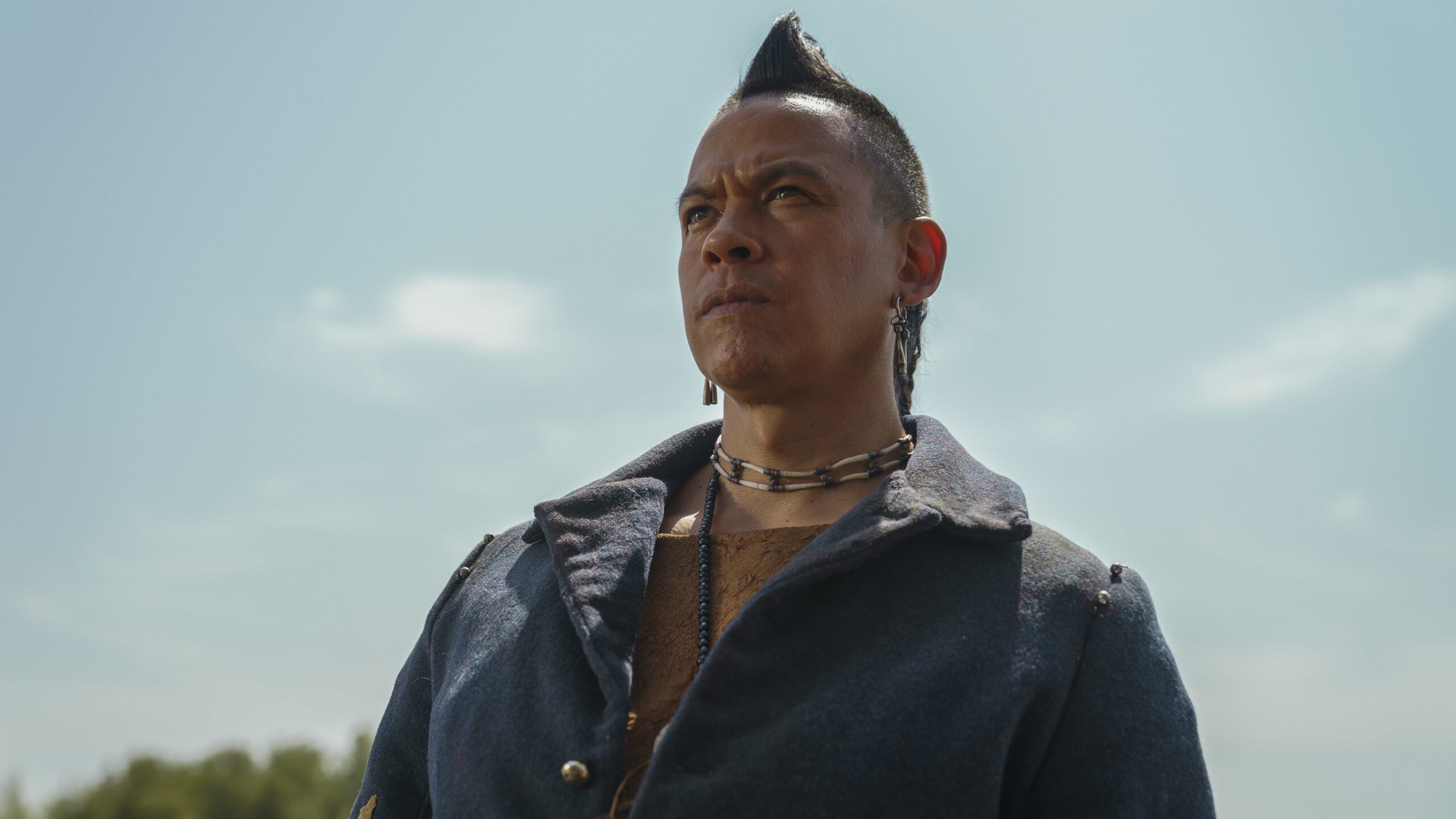 Eli looks up outside in The English